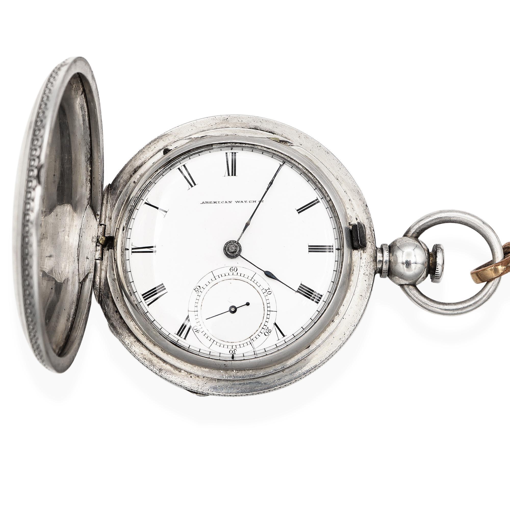 A distinguished Waltham pocket watch, crafted in Waltham, Massachusetts, renowned for its legacy in fine watchmaking. This elegant timepiece features a coin silver case, beautifully adorned with an intricate engraved crest on the front, adding a