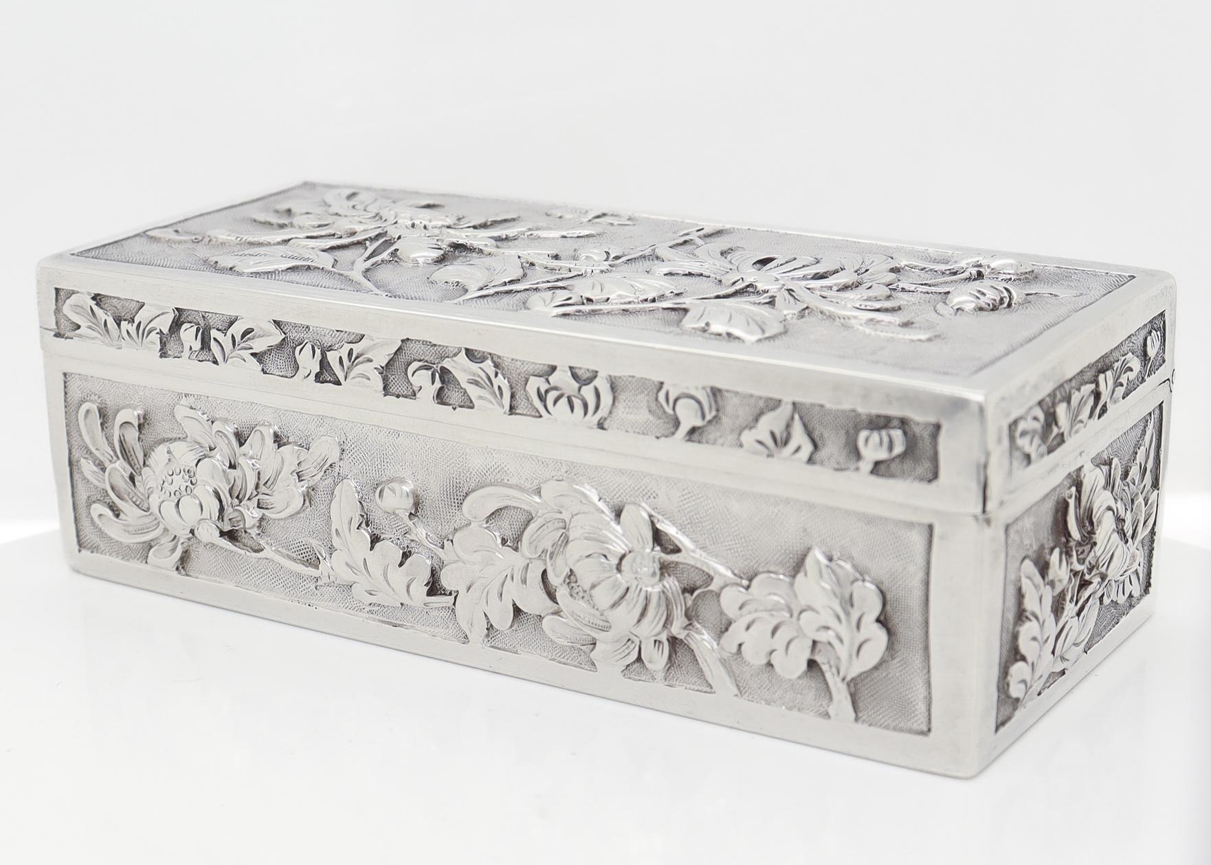 A fine antique Chinese export silver box.

By Wang Hing & Co. of Hong Kong.

In a rectangular form with repousse chrysanthemum decoration on a stippled ground throughout.

Marked to the base with WH for Wang Hing / 90 for silver fineness / and an