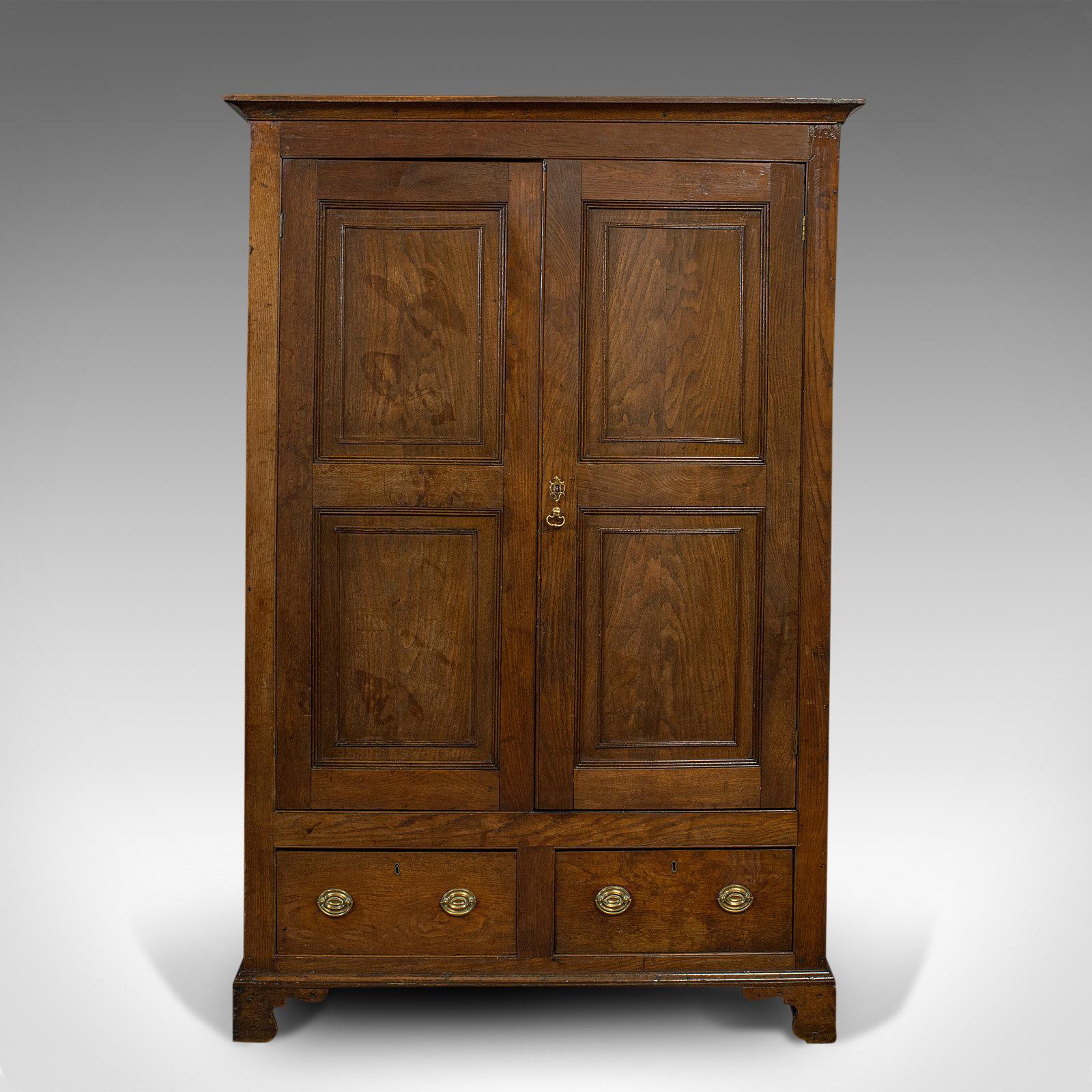 This is an antique wardrobe. An English, oak linen cabinet or press cupboard, dating to the Georgian period and later, circa 1800.

Grand proportion and coloration
Displays a desirable aged patina
Select oak shows fine grain interest and wisps