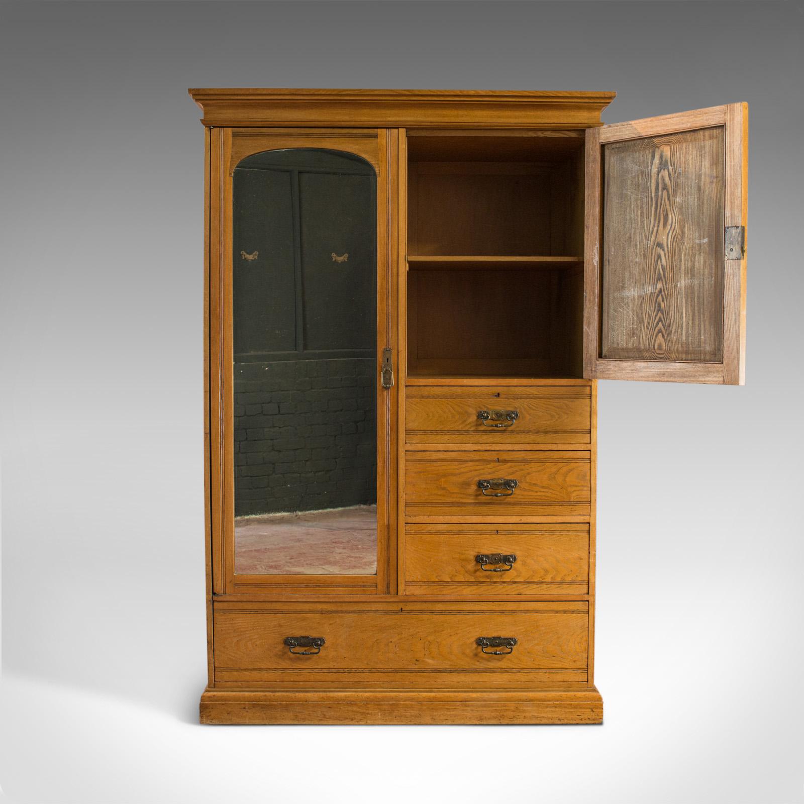 This is an antique wardrobe by Howard and Sons of London. An English, oak linen cupboard, or compactum, dating to the late 19th century, circa 1900.

Crafted in select oak displaying rich biscuit hues with consistent tone
Grain interest