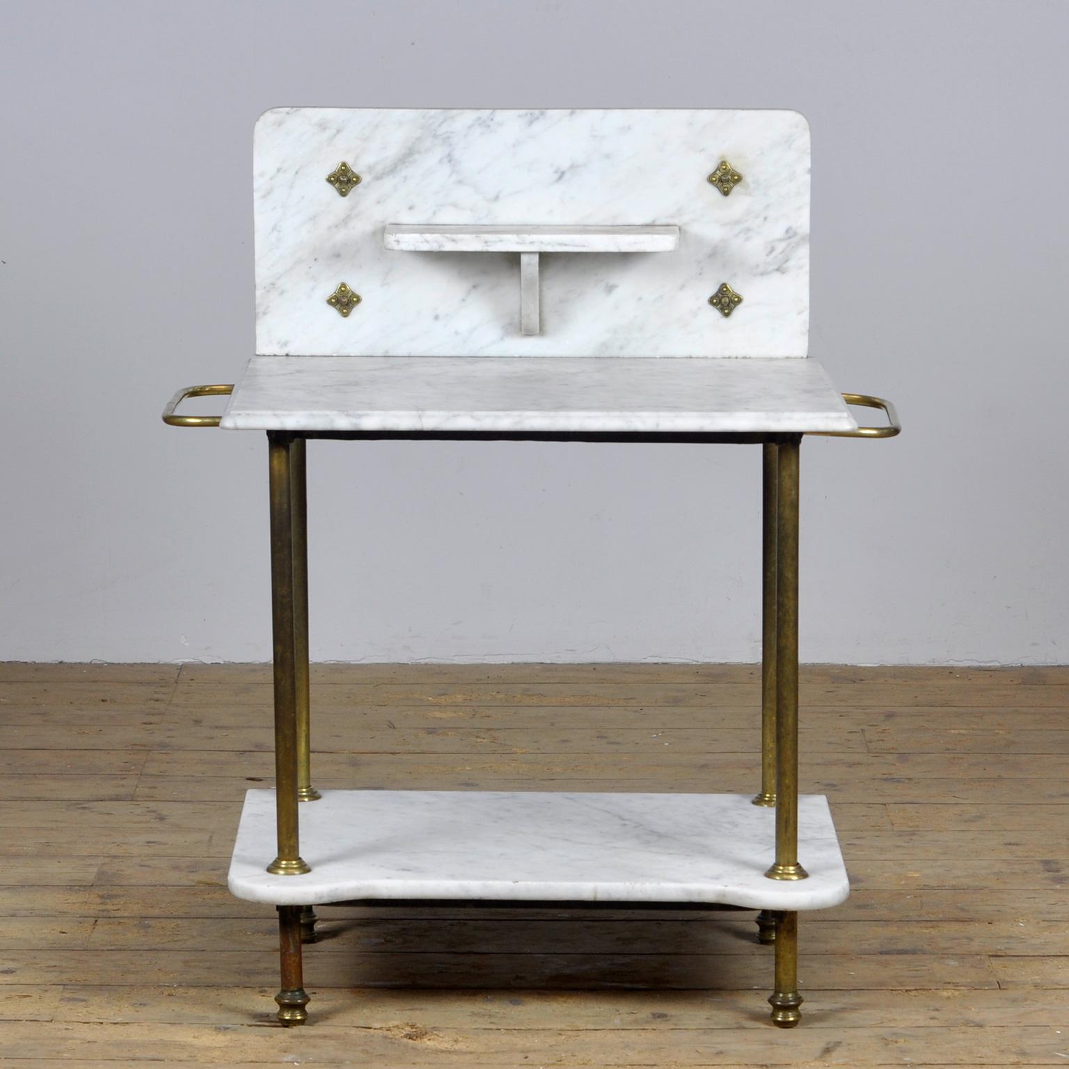 Antique brass and marble washbasin from circa 1880. High quality brass and marble washbasin with compact proportions. Just right for a smaller bathroom or sink. Solid and strong, and in good condition. Has two towel rails.
Height of the marble top
