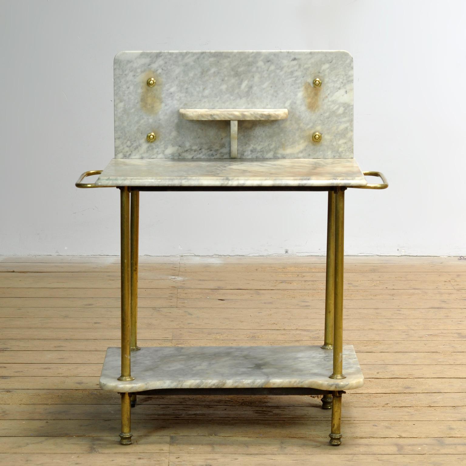 Antique brass and marble washbasin from circa 1880. High quality brass and marble washbasin with compact proportions. Just right for a smaller bathroom or sink. Solid and strong. Has two towel rails. The height of the top is 72cm.