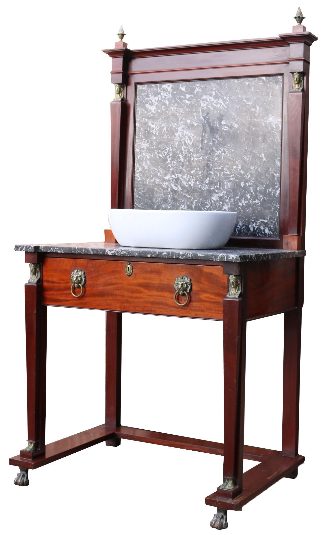 This beautiful washstand is made from mahogany and a grey/white marble with brass embellishments in the Egyptian taste. The basin is made from porcelain but has not been fitted.

We have paired this original wash stand with a modern basin to show