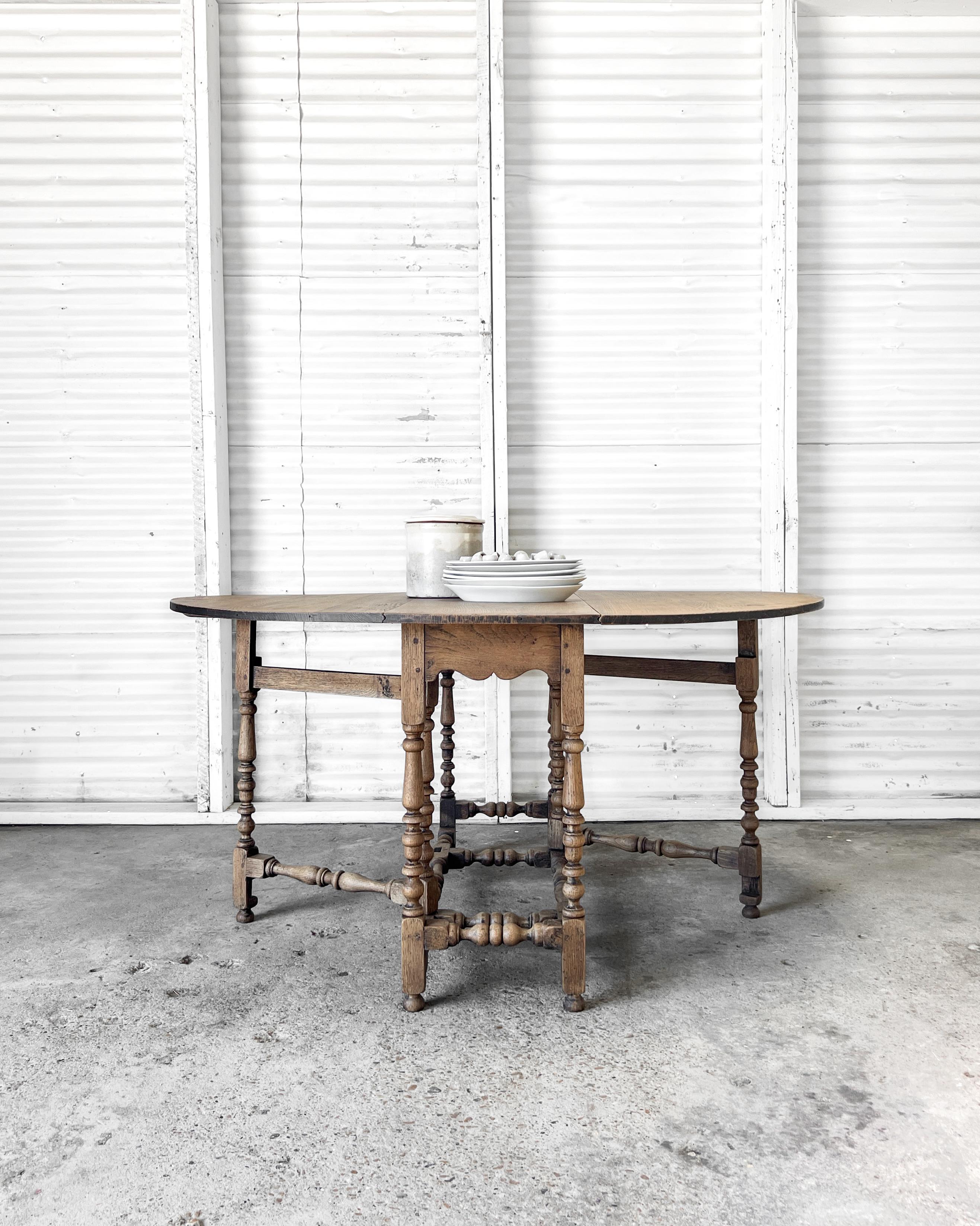 Perfect for gathering around during dinner parties, lazy weekend breakfasts, or simply working on weeknight homework assignments, this lovely antique drop-leaf, gate leg table is not only beautiful but is a charming multitasking accent table that