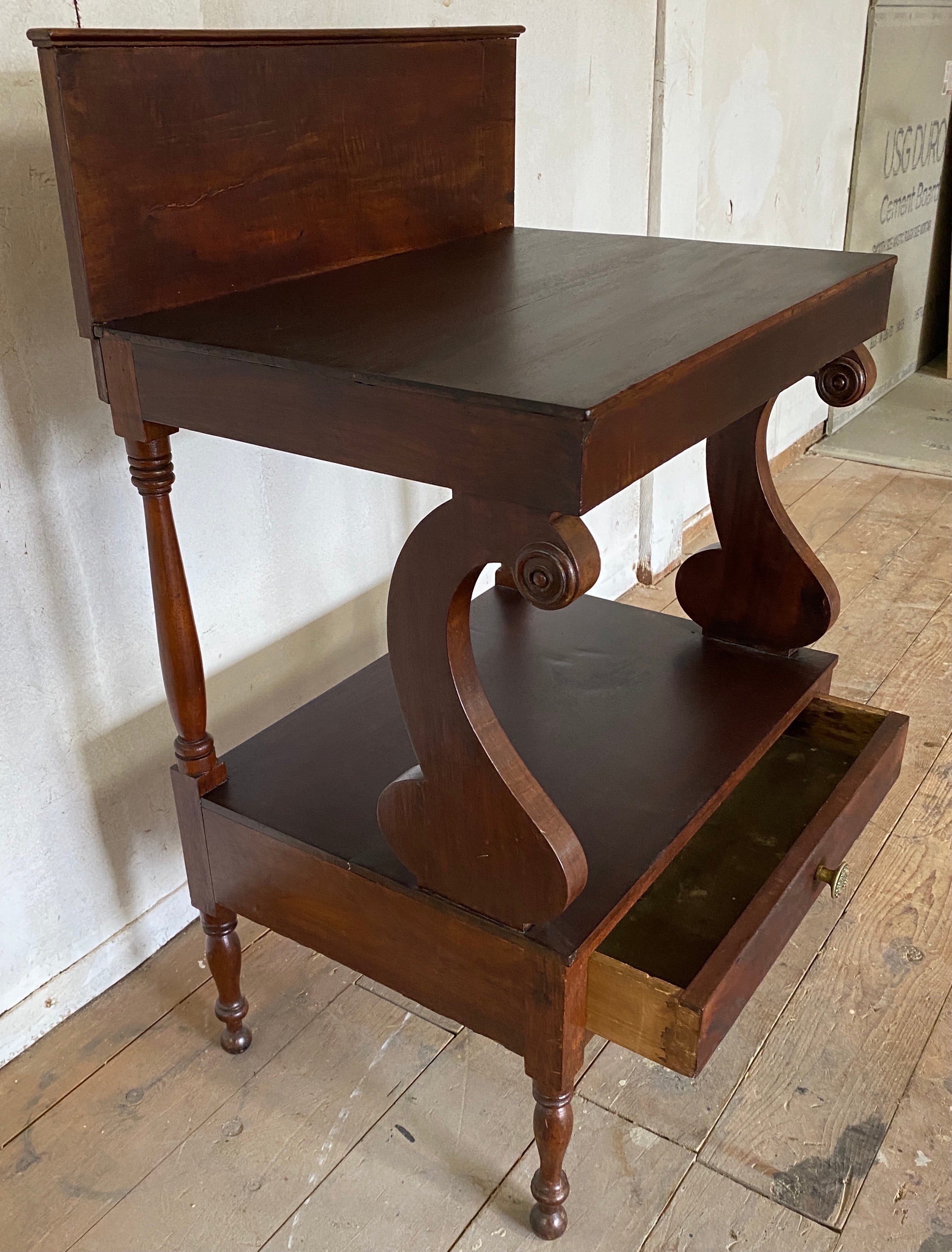 19th century two tier washstand with rectangular shaped backsplash and single drawer below.
Stand height w/out back splash = 28.25.
Top: 15.75 d to backsplash/13
