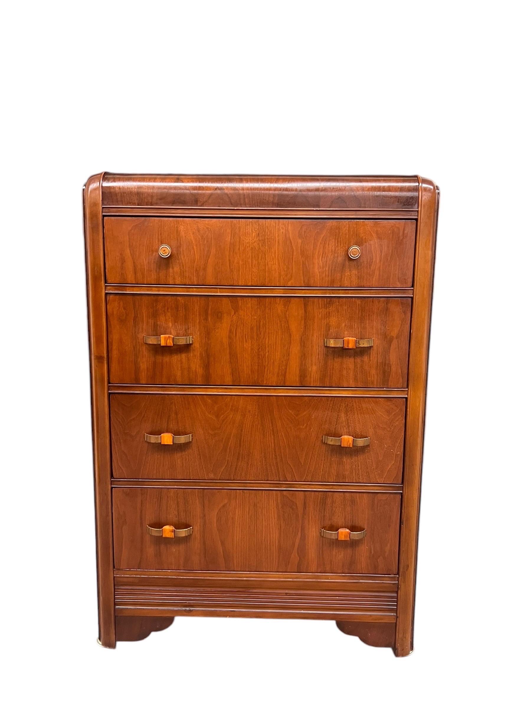 This antique retro waterfall dresser features a distinctive Art Deco design, characterized by its smooth, curved lines that resemble cascading water. The dresser is typically made from hardwood, likely mahogany or walnut, which provides a warm, rich