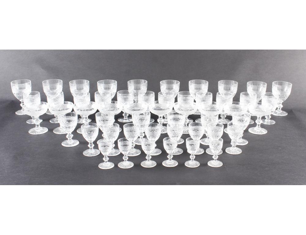 A large beautiful 51 piece waterford crystal cut glass service circa 1900 in date.
The service features a plain sharp diamond pattern with facet below on a knopped stem with a star burst base, some signed Waterford.

10x champagne 
10x red