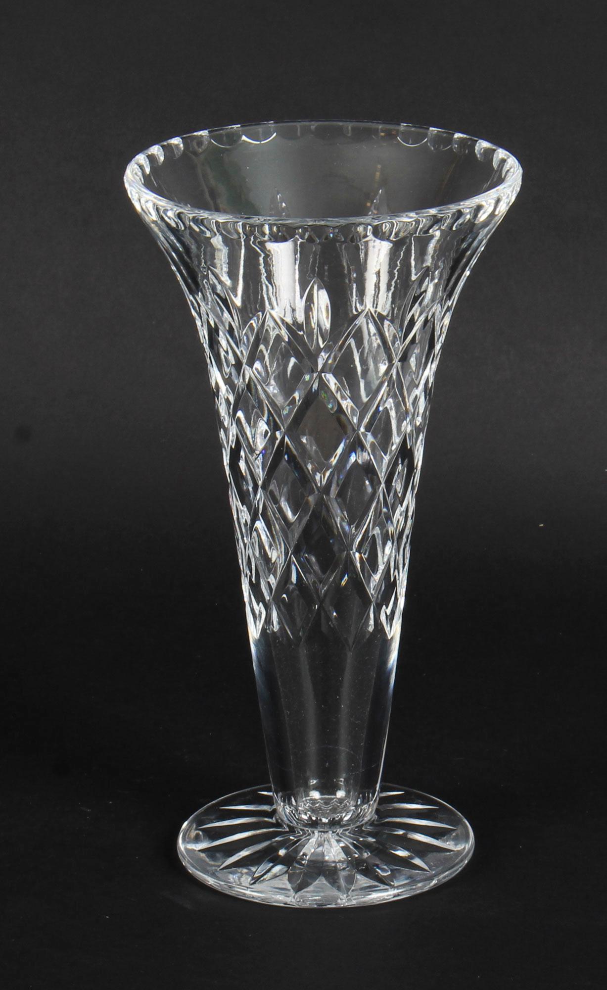 This is a splendid  antique Waterford cut crystal vase, circa 1900 in date.
 
This wonderful vase has a delightful sloping neck which is ideal for almost any floral arrangement, while the vase itself boasts stability and comforting weight. It