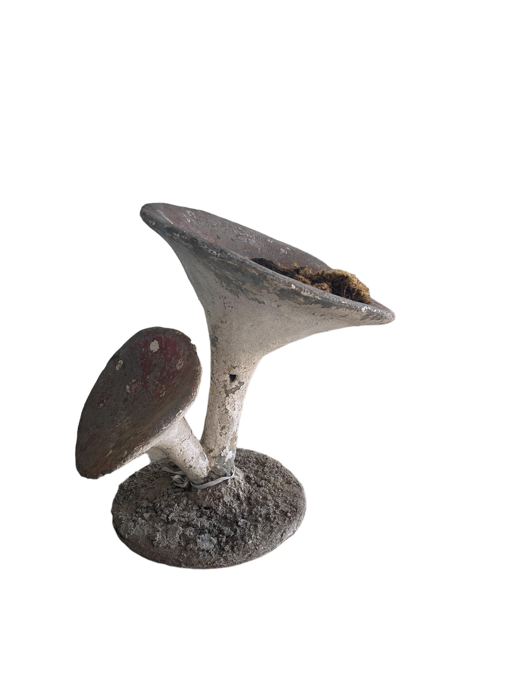Transform your garden with these exquisite Antique Weathered French Cast Concrete Garden Mushrooms. Each mushroom bears the patina of time, adding rustic charm to your outdoor space. Crafted with old world charm, these durable concrete mushrooms