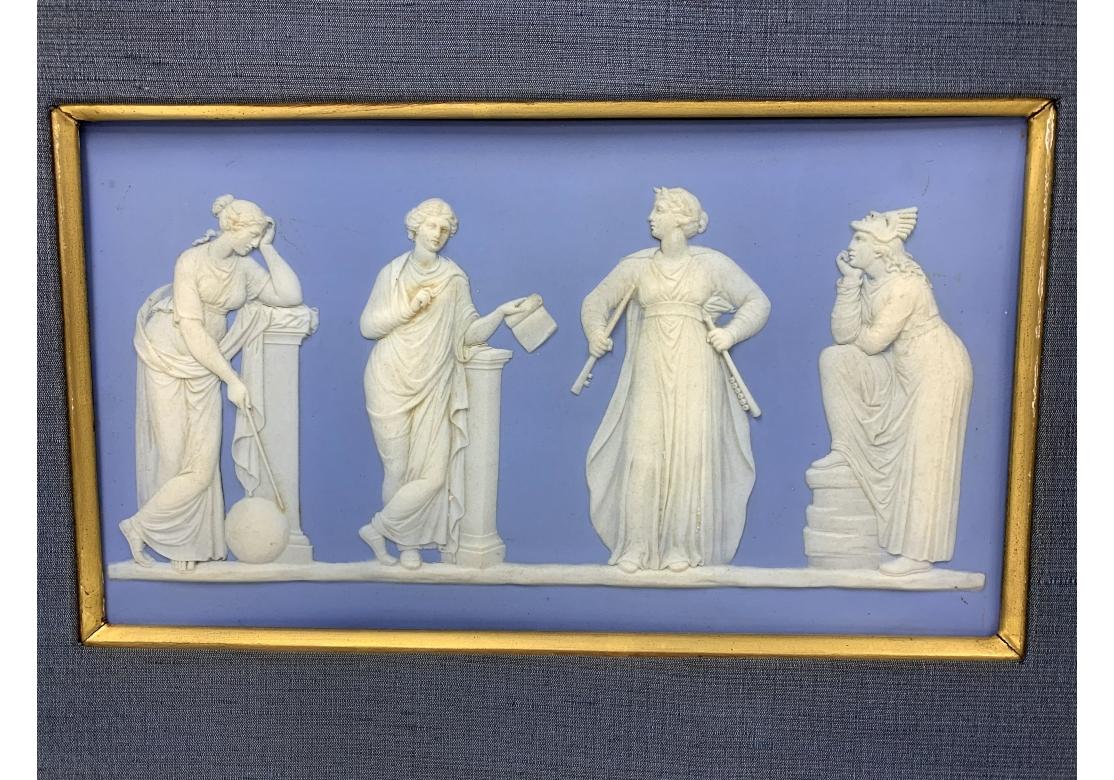 A fine Wedgwood large blue and white jasperware plaque with the company impressed mark on verso. Four of the nine Greek Muses are shown standing in their classical poses with their individual attributes: Urania Muse of Astronomy is shown with her