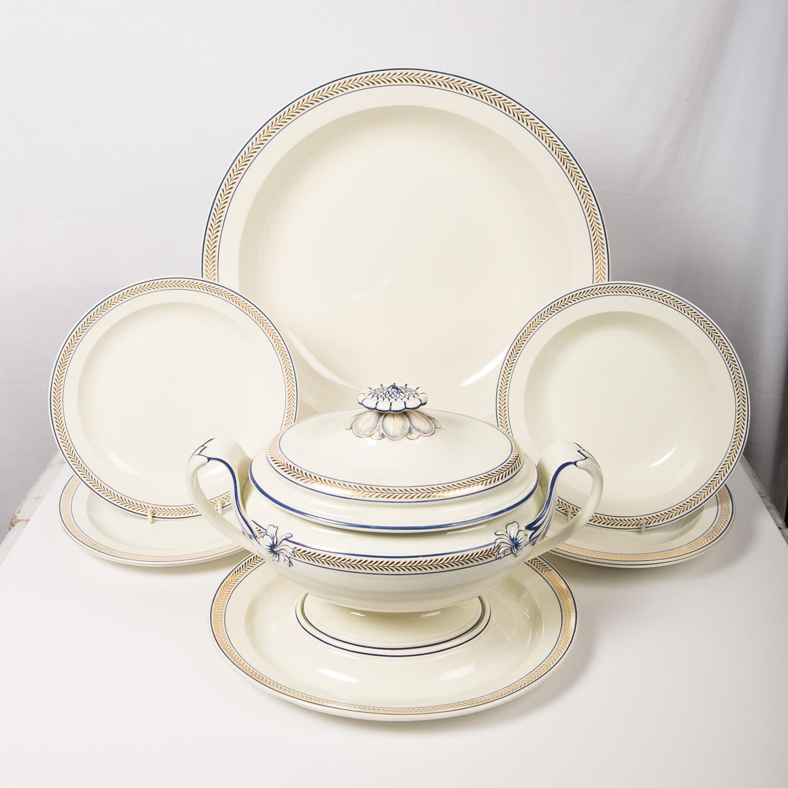WHY WE LOVE IT: Understated yet elegant.
We are pleased to offer this large and extensive Wedgwood creamware dinner service decorated with a border featuring gold chevrons set between two enameled blue lines. This pattern was first introduced by