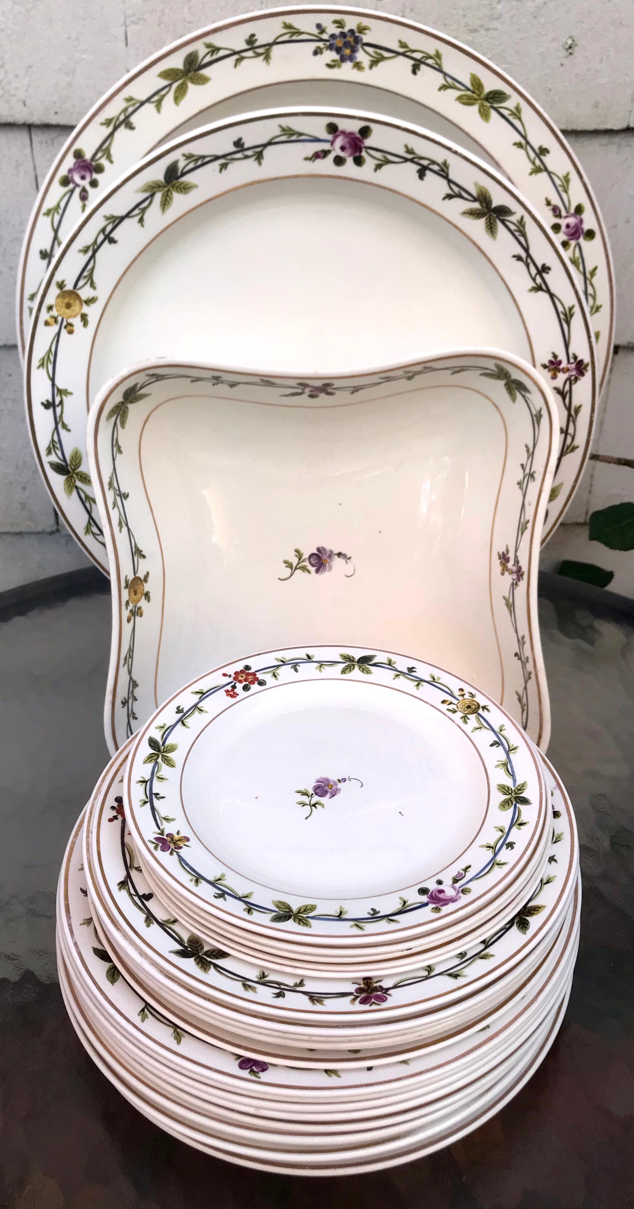 Antique Wedgwood creamware floral banded part service. Set of English creamware dishes comprising two large round serving plates, one shaped serving bowl, eight 9” plates, six medium plates and six small plates all with green leafy band with flowers