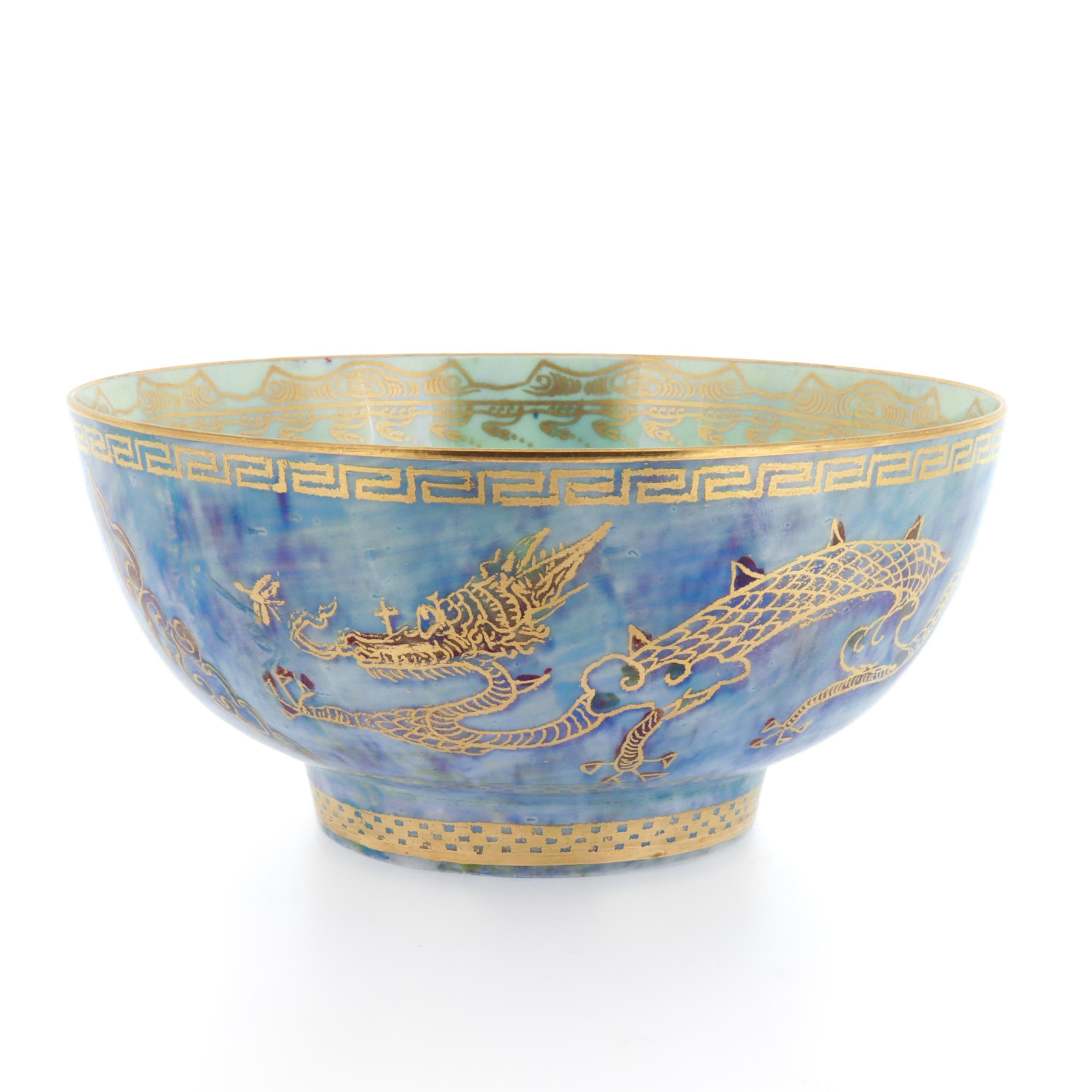 A fine antique English lustreware porcelain bowl.

By Wedgwood.

Pattern no. Z4829

Shape no. 2351

Designed by Daisy Makeig-Jones.

With a mottled blue exterior and mottled celadon interior. Decorated throughout with gilt geometric devices, and