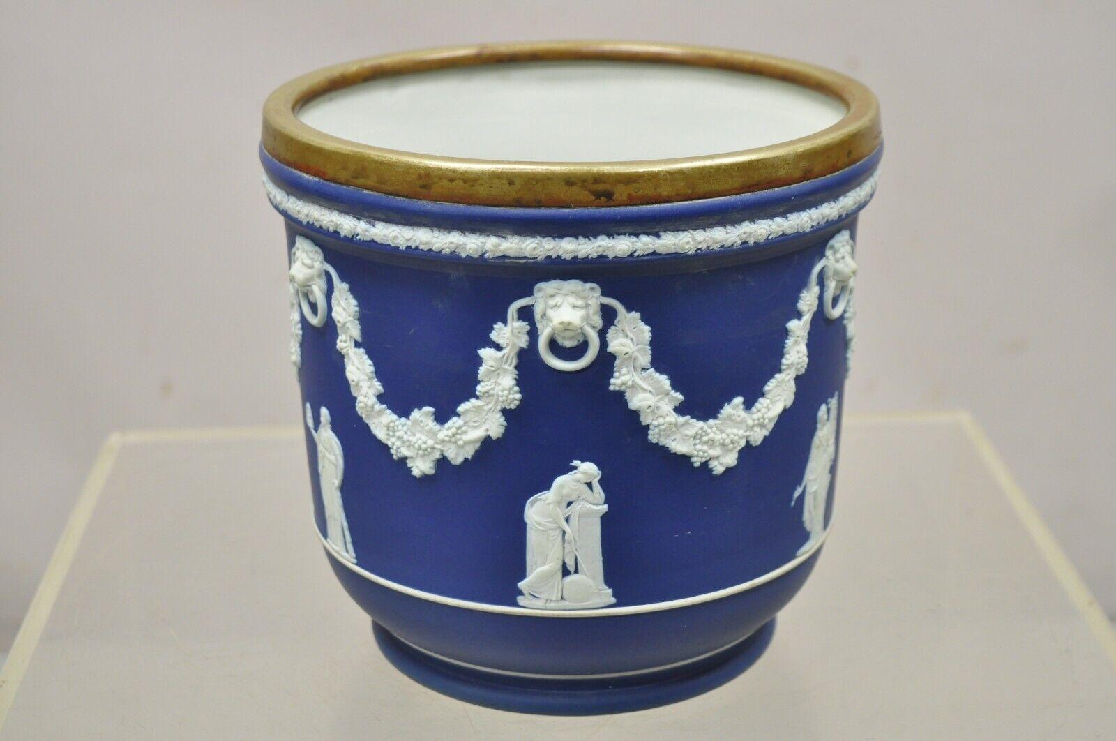 Antique Wedgwood England blue Jasperware cache pot with brass rim. Item features a brass rim with wonderful patina, original stamps to underside, circa late 19th to early 20th century. Measurements: 8