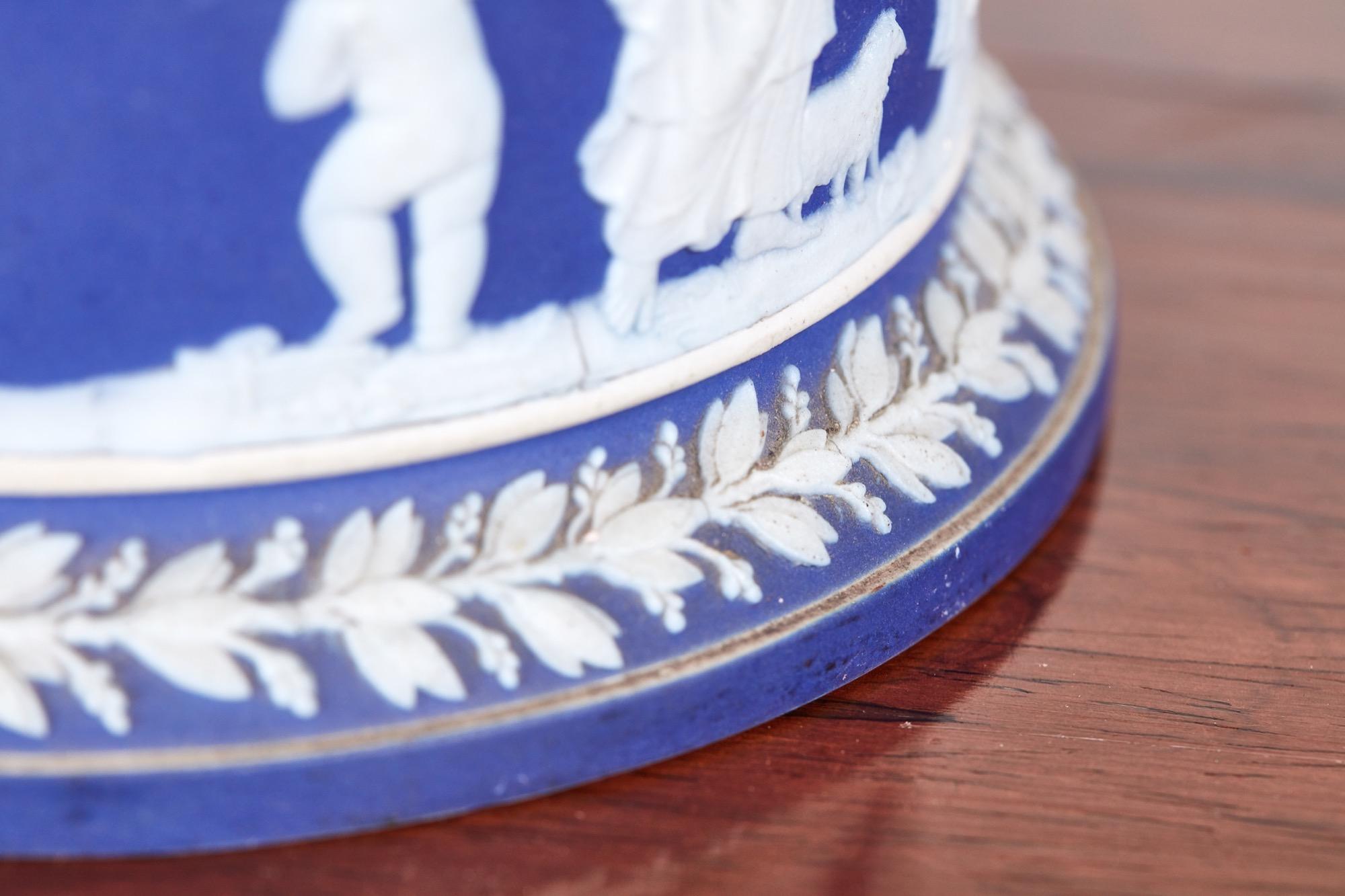 Antique Wedgwood jasperware biscuit barrel, the body decorated with classical scenes in a white cameo a blue back ground, swing silver plated handle, the base marked Wedgwood
Lovely condition
Measures: 4