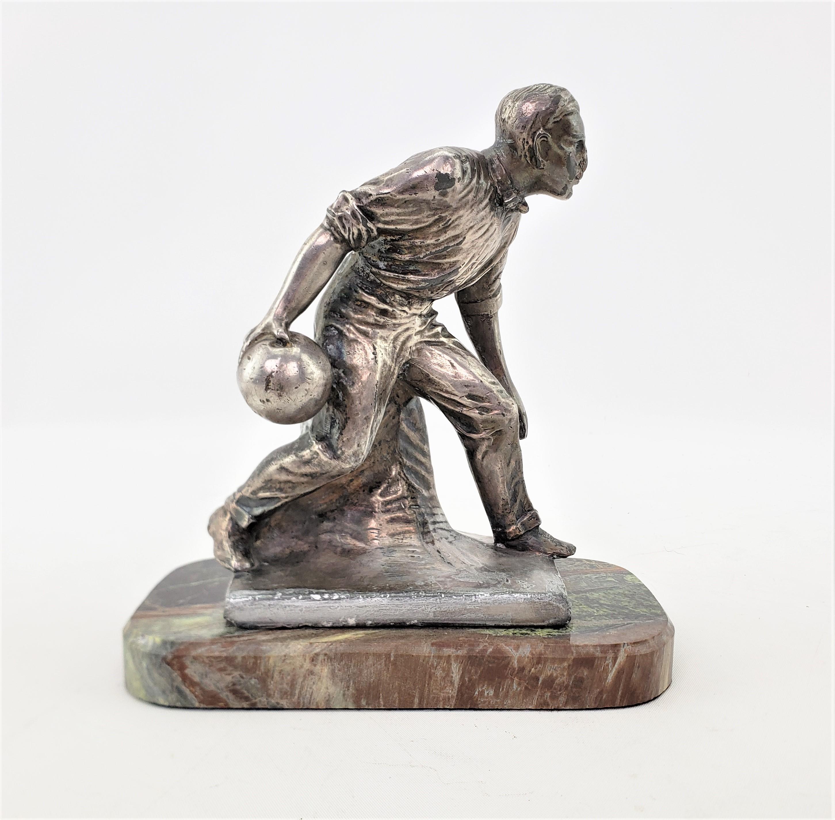 This sculpture was made by the Weidlich Brothers Manufacturing Company of the United States in approximately 1920 in the period Art Deco style. The sculpture is composed of silver plate over cast metal and depicts a man bowling in period attire. The