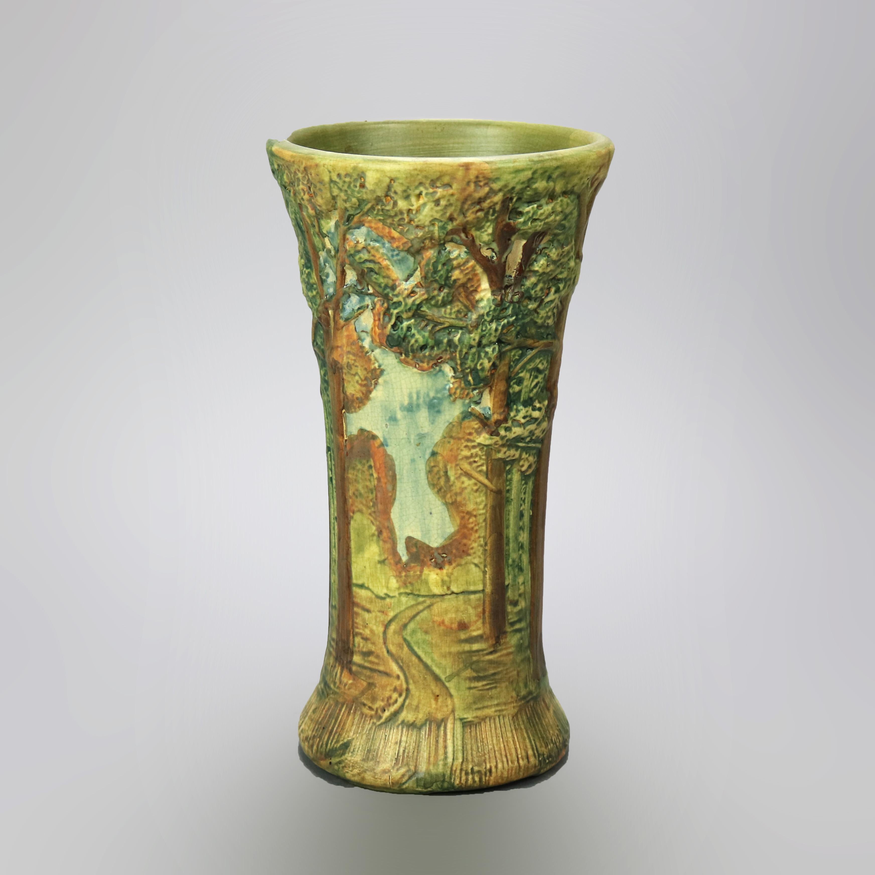 An antique vase by Weller in the Forest pattern offers art pottery construction in hourglass form with polychrome all-around landscape scene in relief, unsigned, circa 1930

Measures - 12''H x 6.25''W x 6.25''D.