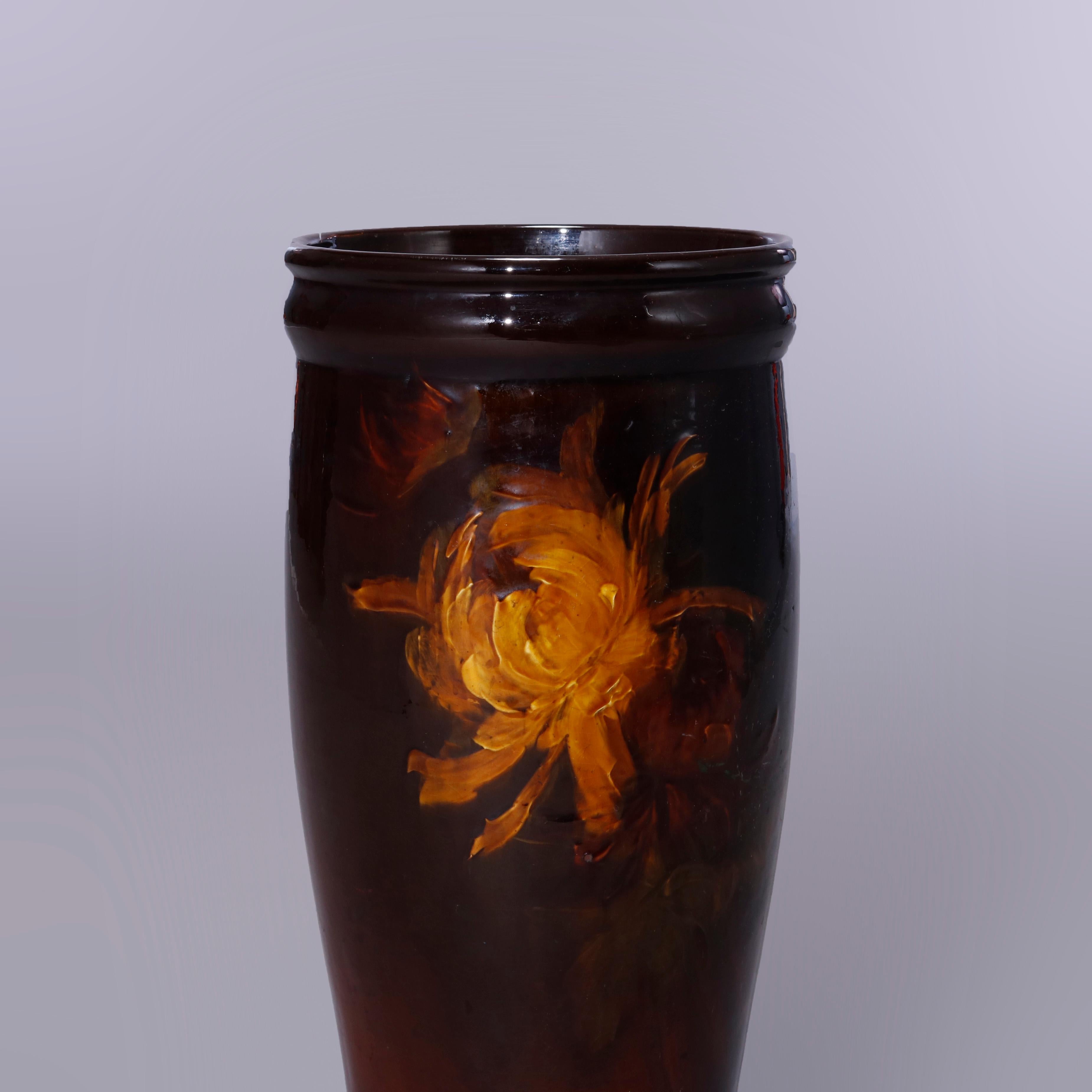 An antique umbrella stand by Weller offers art pottery with hand painted floral reserve and raised on shaped footed base, signed as photographed, circa 1920

Measures: 20.5