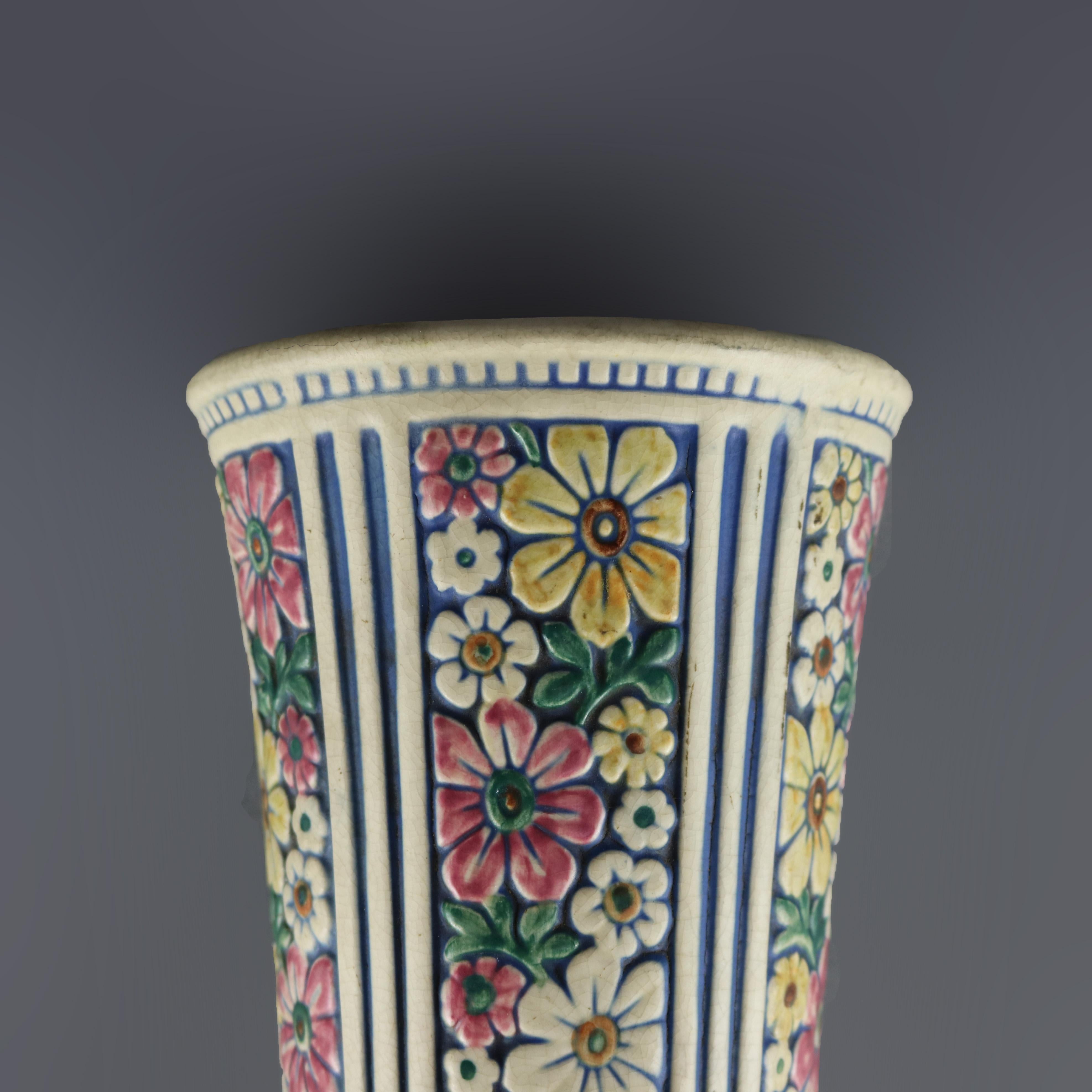 An antique art pottery wall pocket by Weller offers flared vase form with vertical floral over reeded base, maker mark en verso as photographed, circa 1930

Measures: 9.5