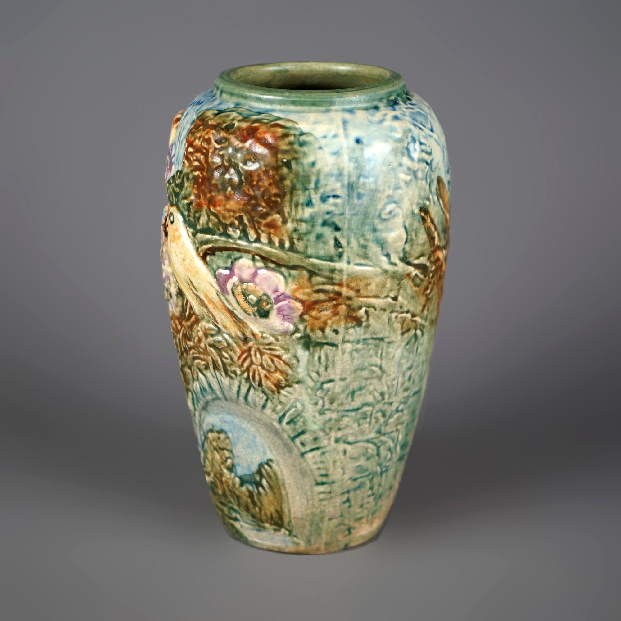 An antique Weller Glendale vase offers art pottery construction with high relief design of woodland setting with gold finches in a nest, c1920

Measures- 8''H x 4.5''W x 4.5''D