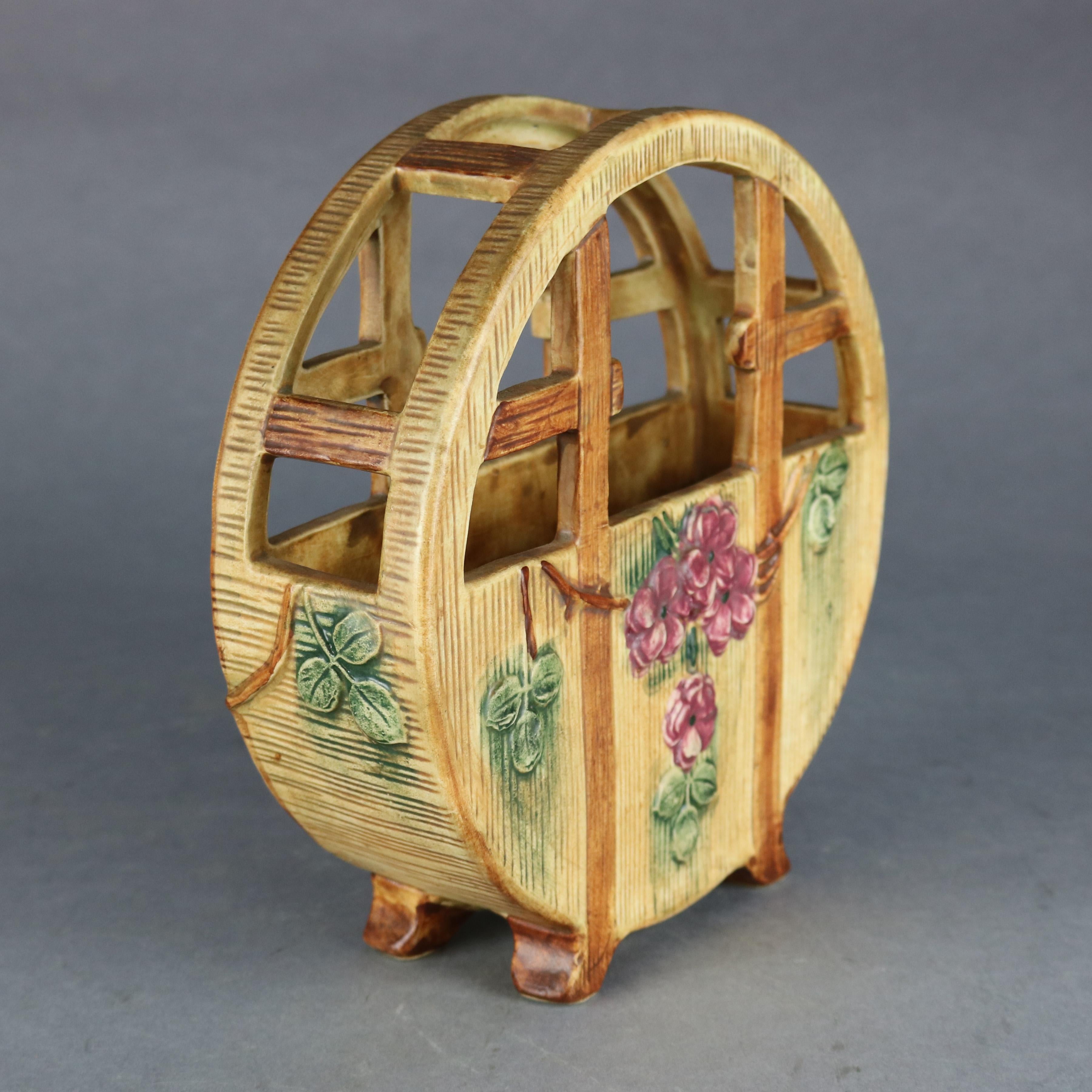 An antique Weller Woodcraft planter offers art pottery construction in circular basket form with flowers, marked on base as photographed, c1930

Measures: 8.5