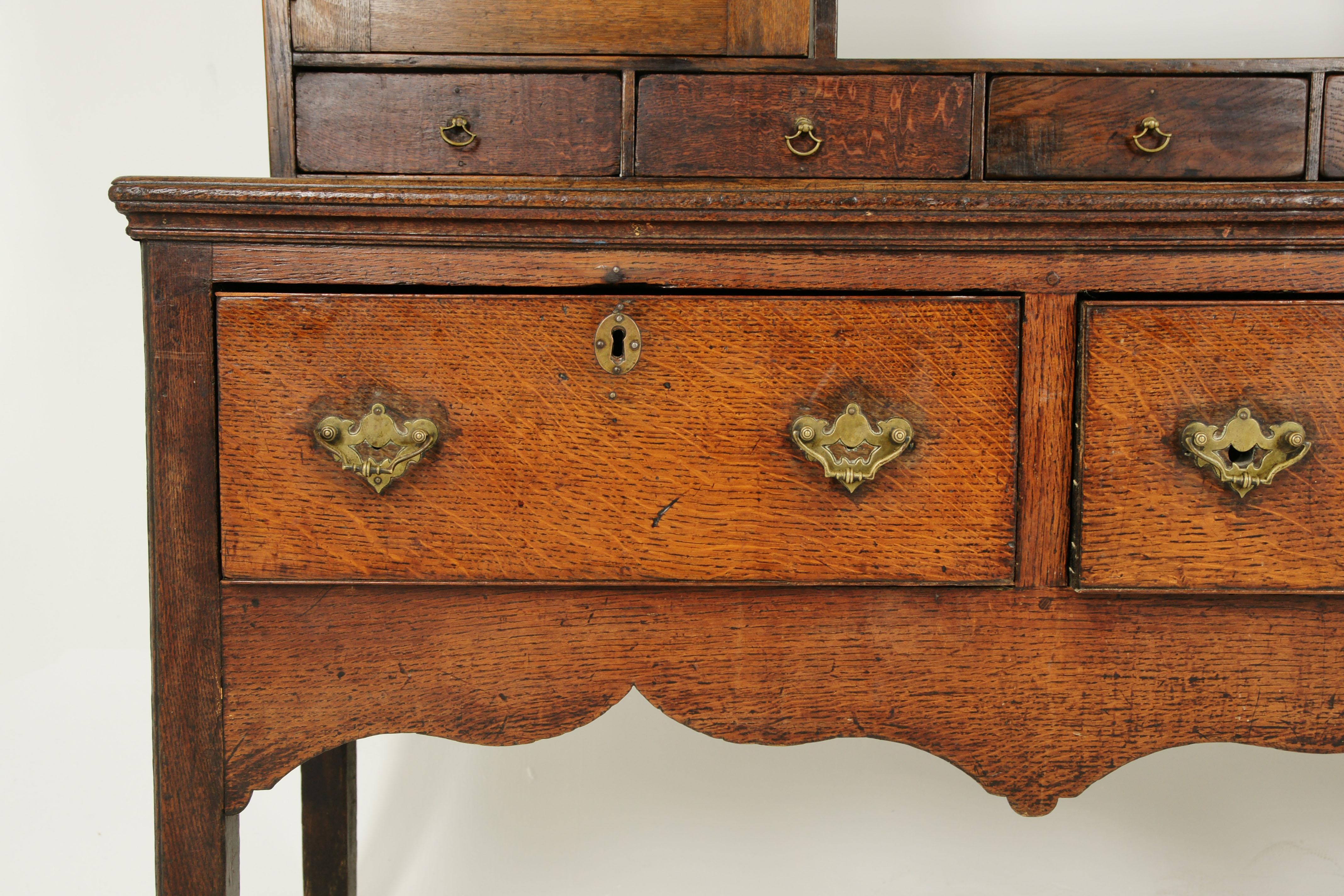 Antique Welsh dresser, oak cottage dresser. Farmhouse Furniture, England 1790, Antique Furniture, B1578.

England 1790
Solid oak construction with original finish
Out turned cornice with scalloped frieze
Graduating plate shelves with molded