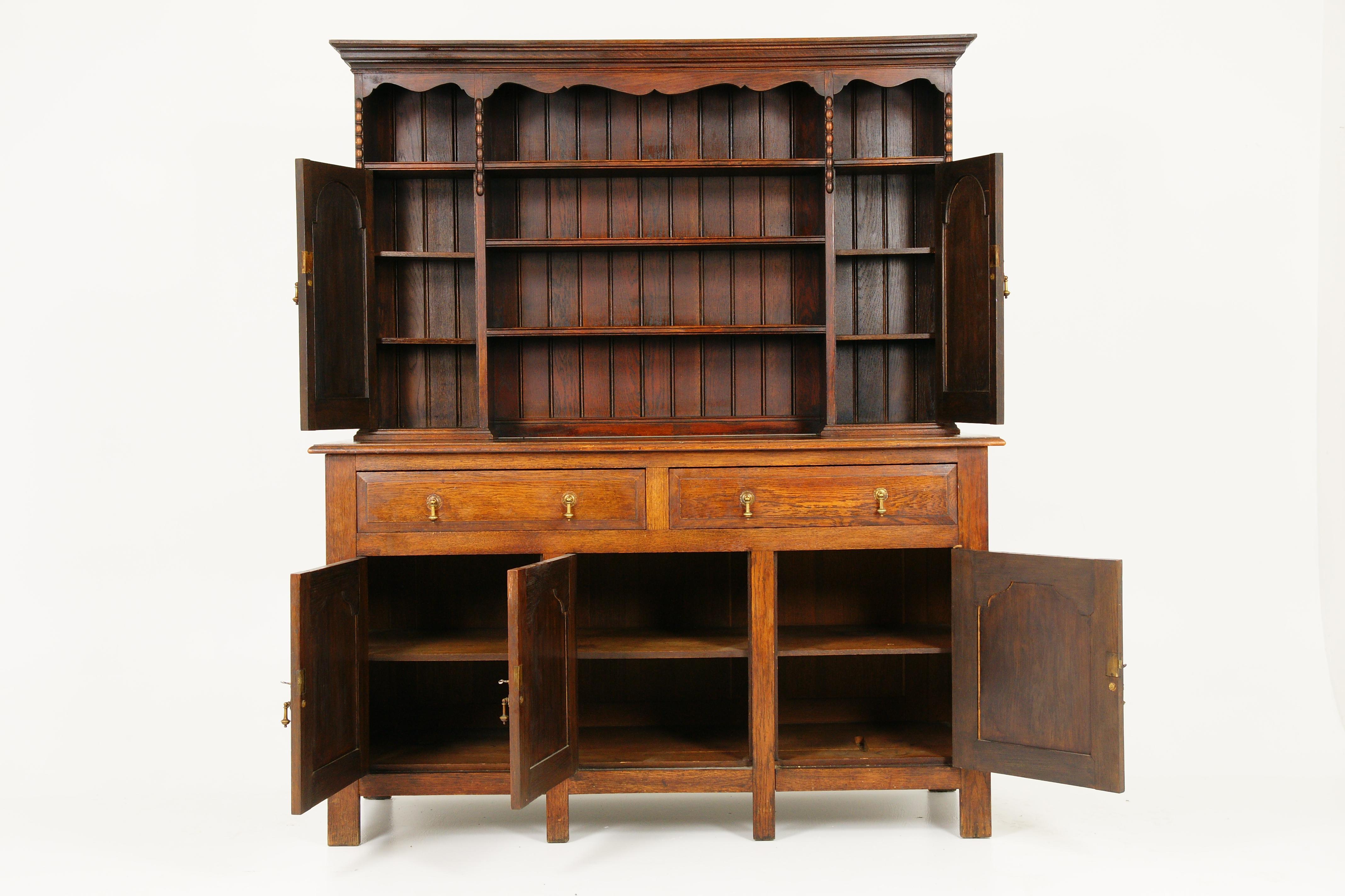 Antique welsh dresser, plate rack oak, Scotland 1920, antique furniture 1643

Scotland, 1920
Solid oak with oak finished shirted cornice above
Three shelves below
Flanked by a pair of panelled doors
All original hardware open to reveal a pair