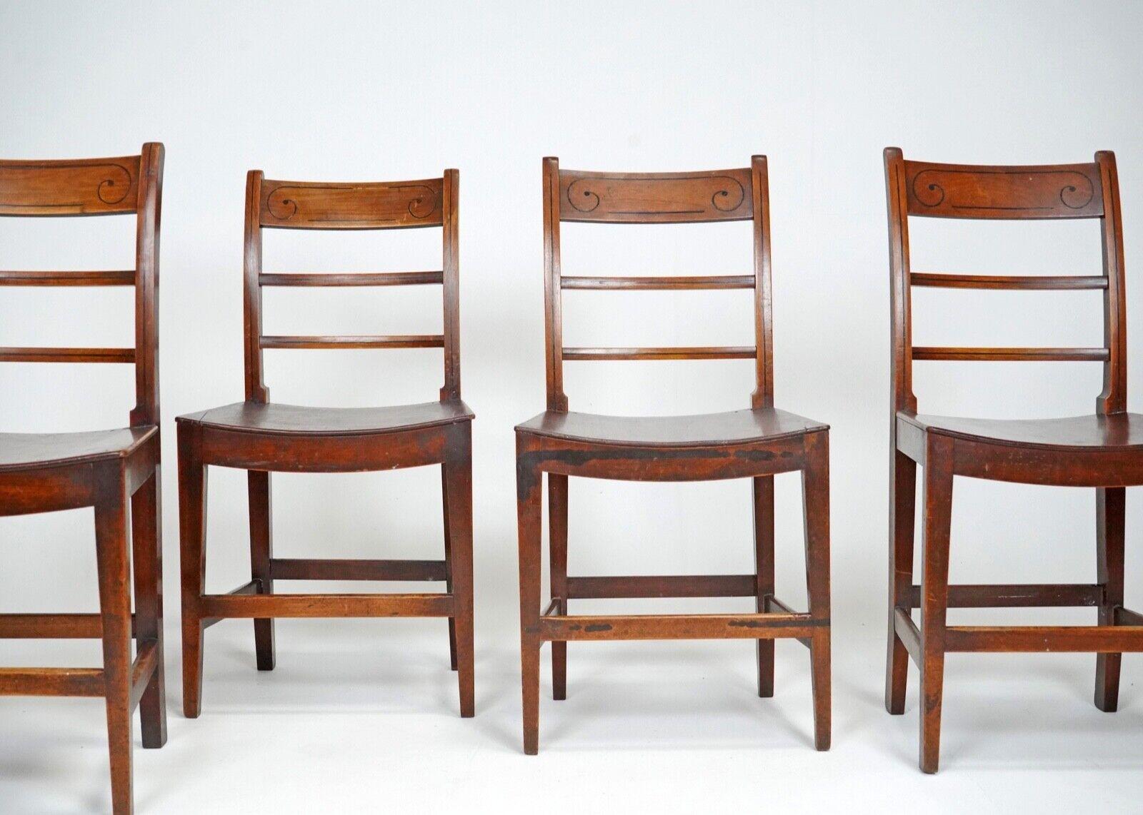 Set of four Welsh farmhouse chairs with a lovely inlaid Daliesque moustache detail that make these chairs a little more special.
Made from solid oak, that has a patina that only comes with age. 
A really charming set of chairs. 
Circa 1900. 
