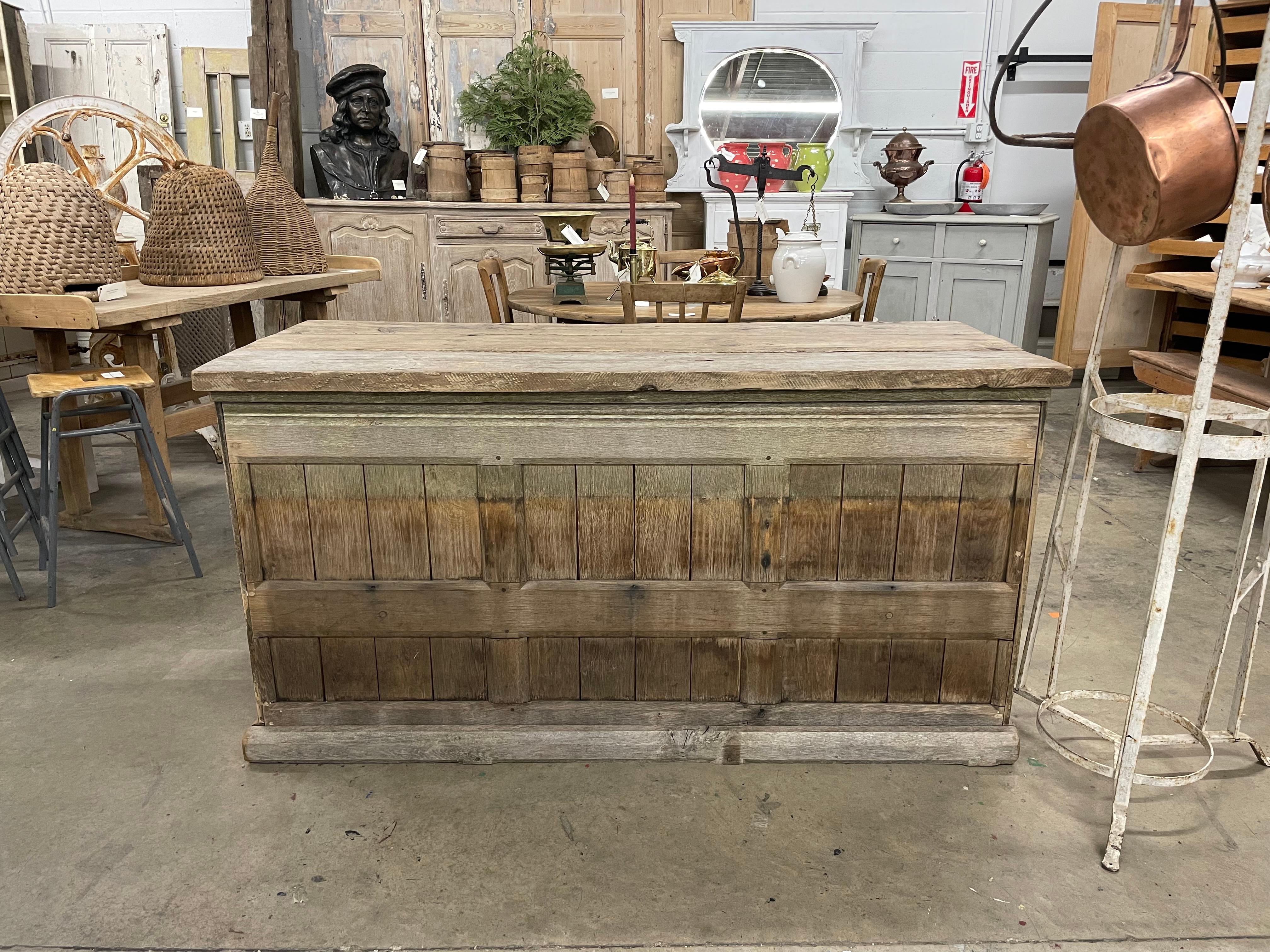 Antique unadorned Welsh rustic oak shop counter with pine top. It has 2 shelves to the back.

Wonderful in a cottage kitchen.