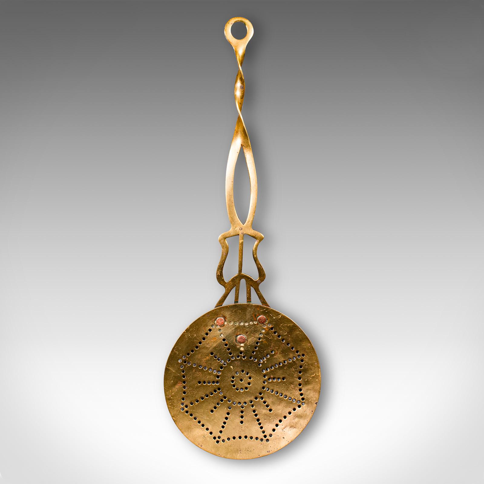 
This is an antique West Country Cream Skimmer. An English, pierced brass milk stirrer, dating to the Georgian period, circa 1800.

Attractive cream skimmer with an appealing decorative finish
Presents a desirable aged patina and in good order
Brass