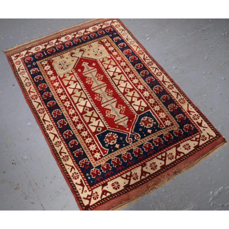 Antique Western Anatolian Bergama region village prayer rug.

A good prayer rug of small size, with bold design and a double birds head at each end. The rug has a floral carnation border on an ivory ground.

The rug has very slight even wear and
