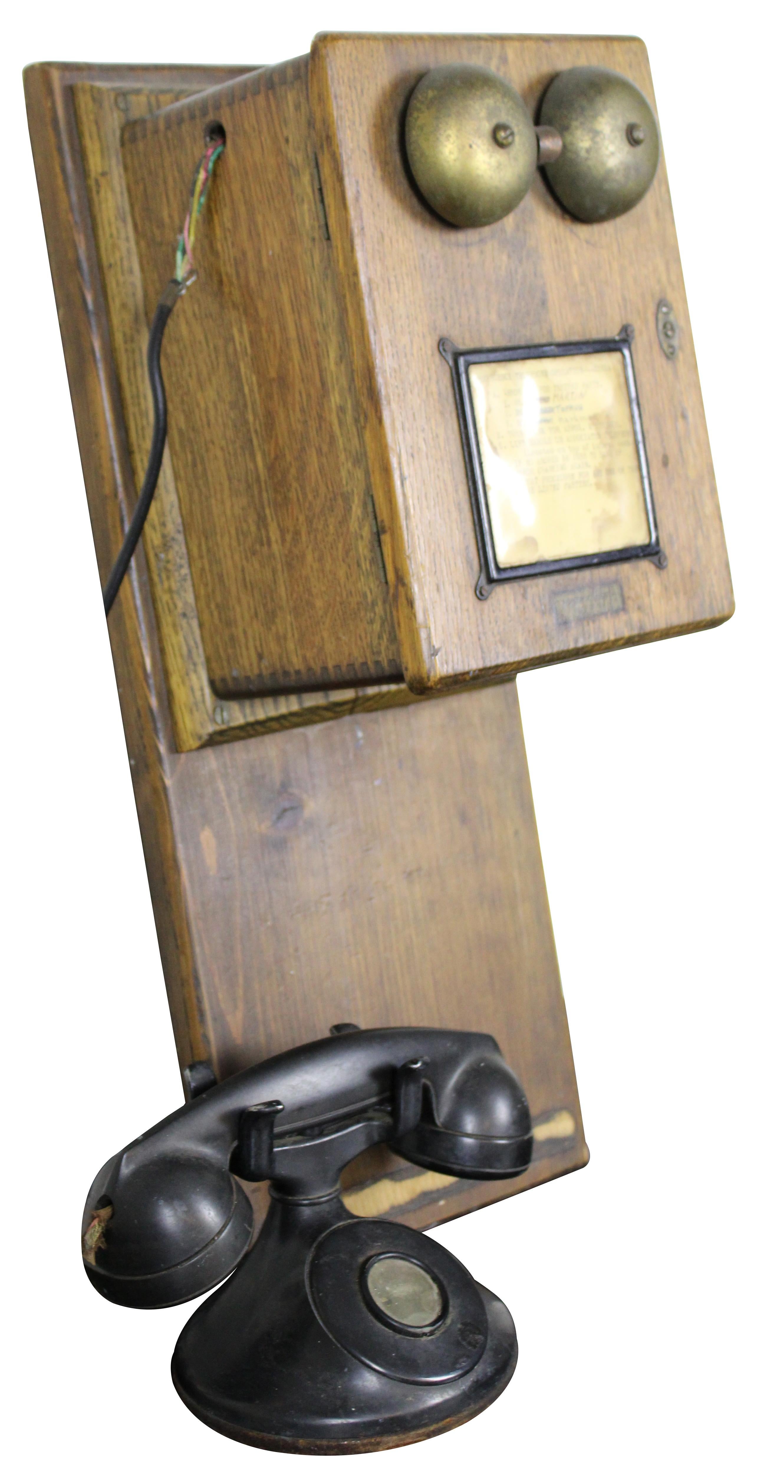 Antique early 1900s Western Electric / bell systems oak wall mounted hand crank telephone ringer box with black bakelite tabletop handset.

Main Section - 9” x 6.75” x 21” / Handset - 8.75” x 5” x 5.75” (Width x Depth x Height).