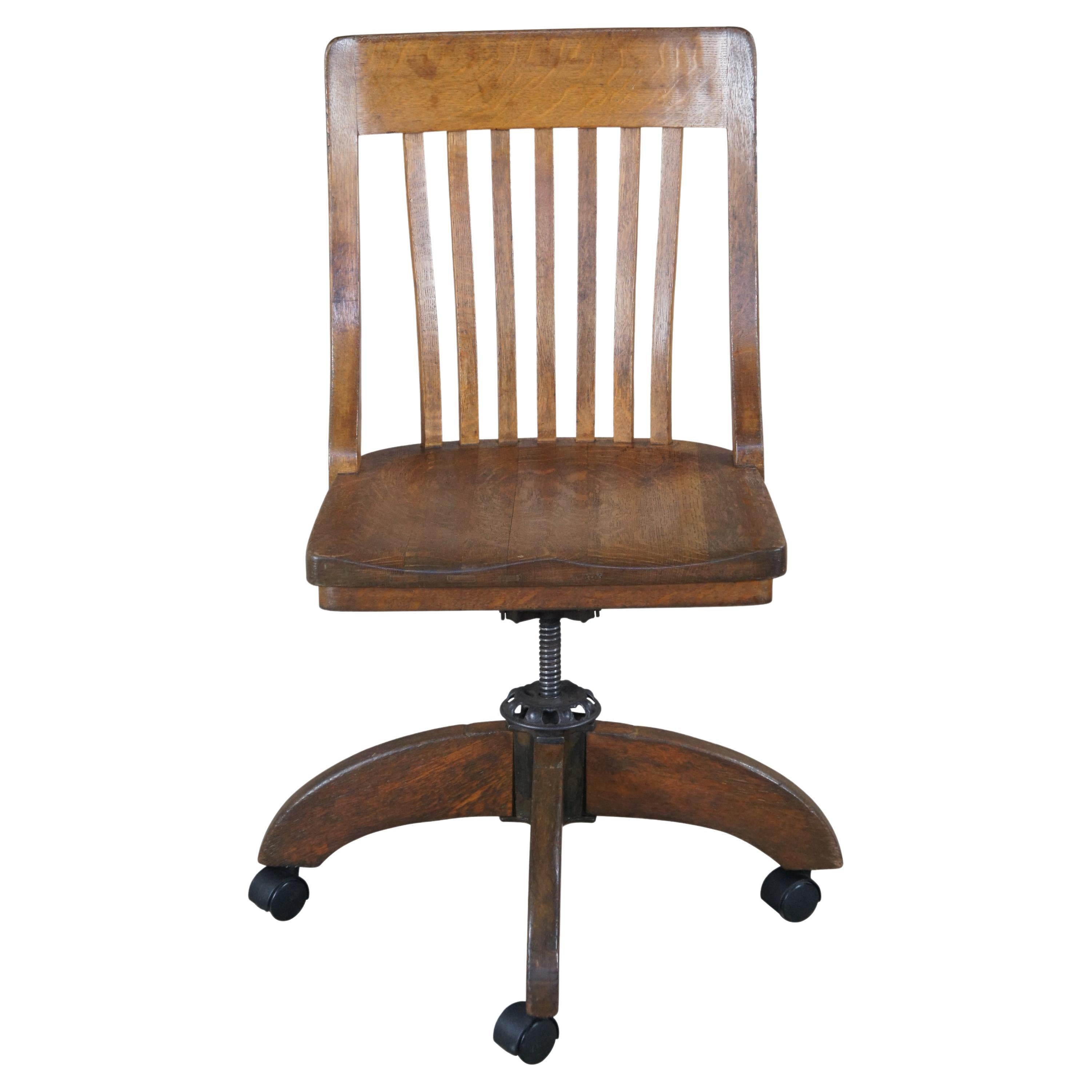 Antique W.H. Gunlocke quartersawn oak bankers / lawyers / executive desk chair featuring a slatted back and adjustable swivel recline.

William Henry Gunlocke entered the chair business in Binghamton in 1888 as a wood finisher and rose to the