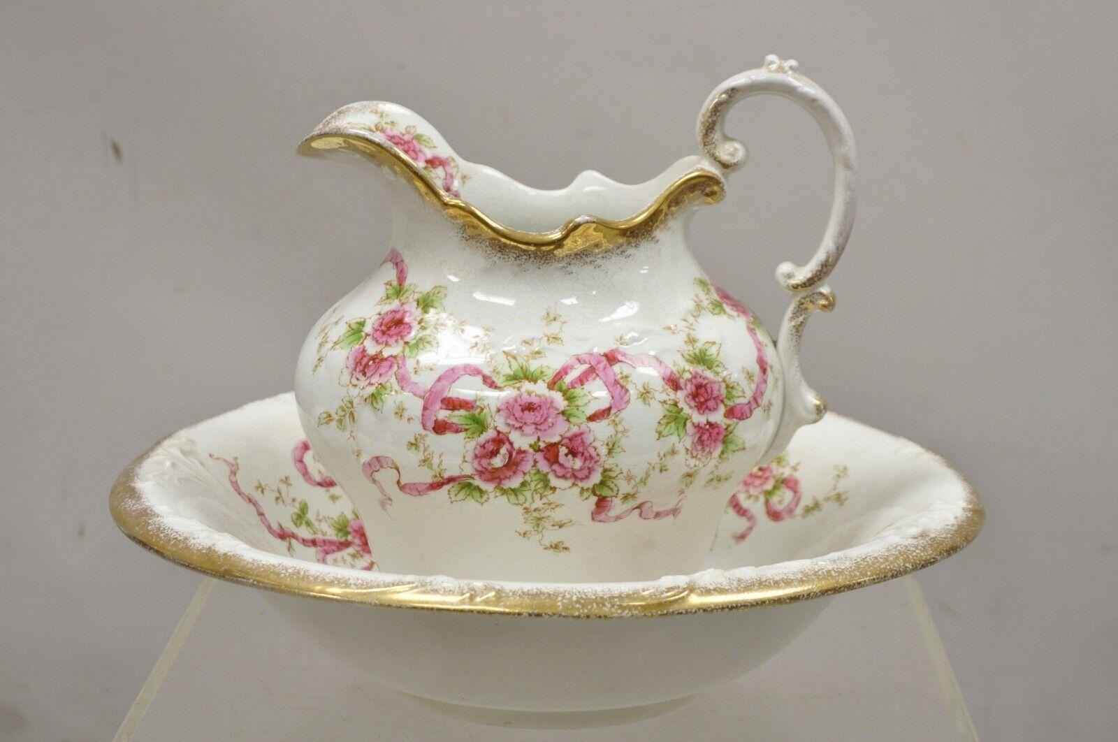 Antique W.H. Tatler Porcelain Pink Rose Flower Wash Basin - 4 Pc Set. Item features (4) pcs, gold gilt details, pink rose flowers, original stamp, includes (1) large jug, (1) smaller jug, (1) large basin, (1) basin with handle. Circa 1900.
