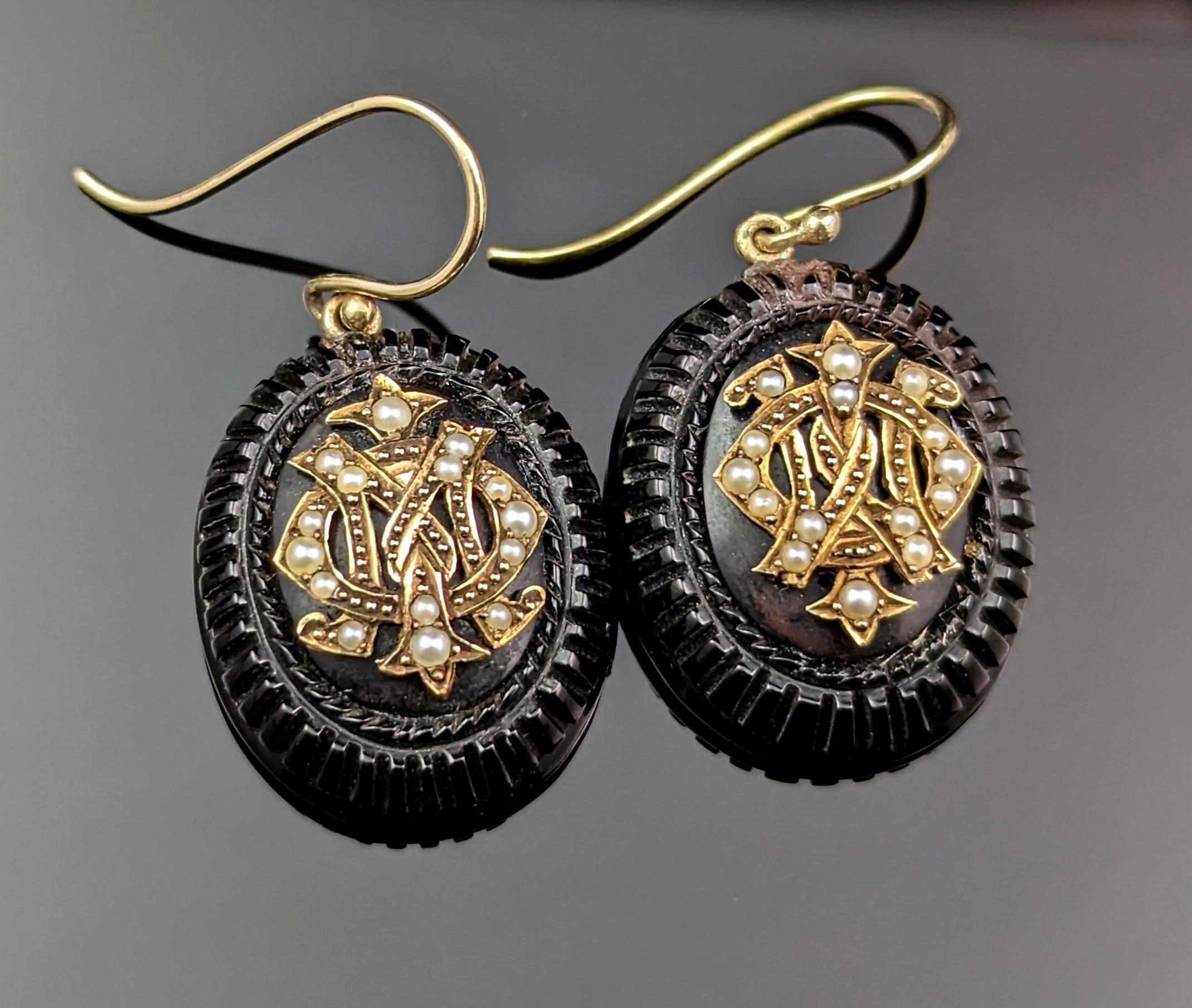This rare and unusual pair of antique Jet Mourning earrings really stand out!

They are conversion earrings, originally starting out life as buttons.

Made from inky black Whitby jet, the earrings are an oval shape with an impressed pie crust type