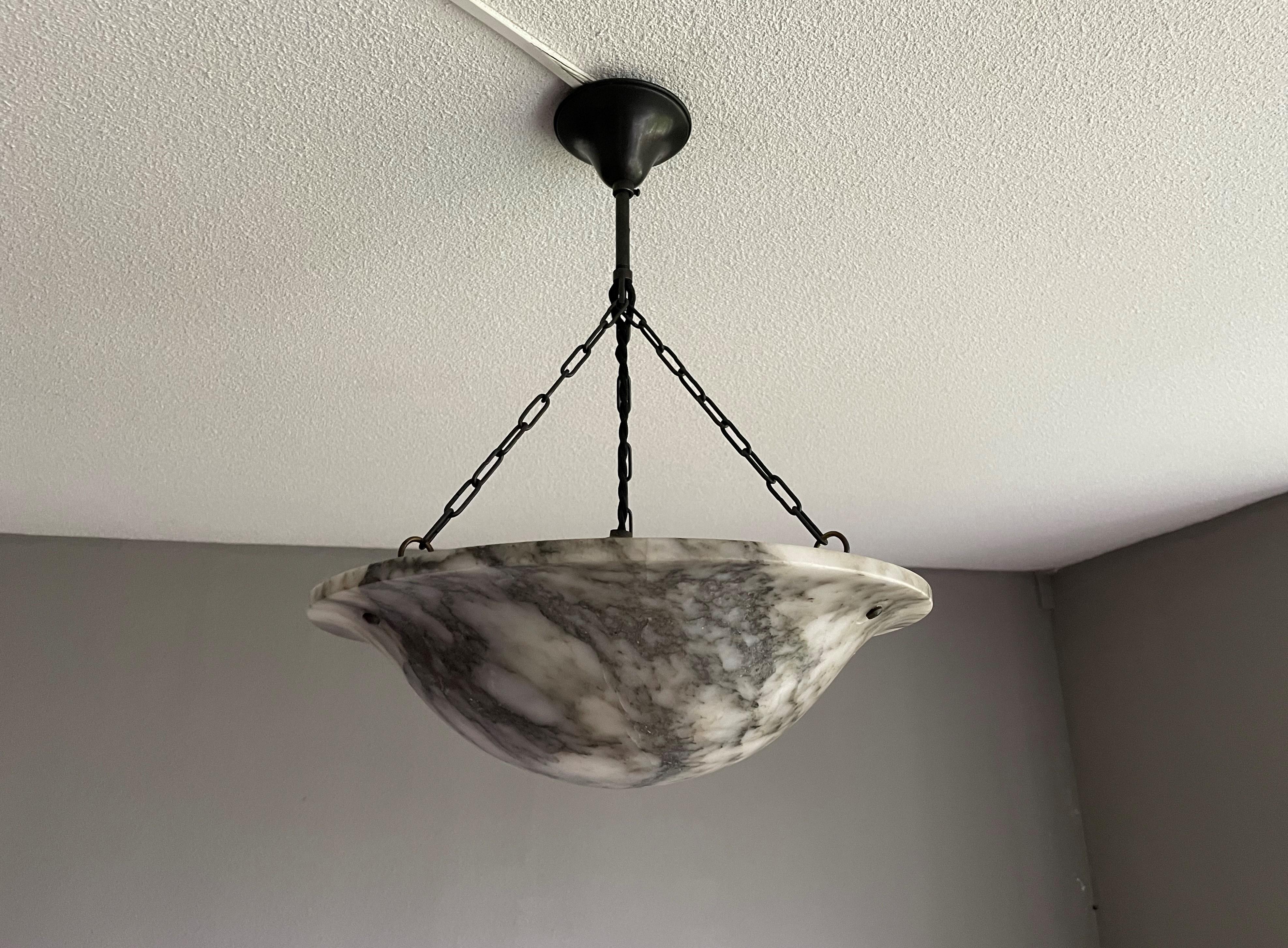 Beautiful and timeless design mineral stone pendant.

If you are looking for an excellent condition and practical size Art Deco light fixture then this fine specimen with its unique black veins and black patches in the shade could be perfect for