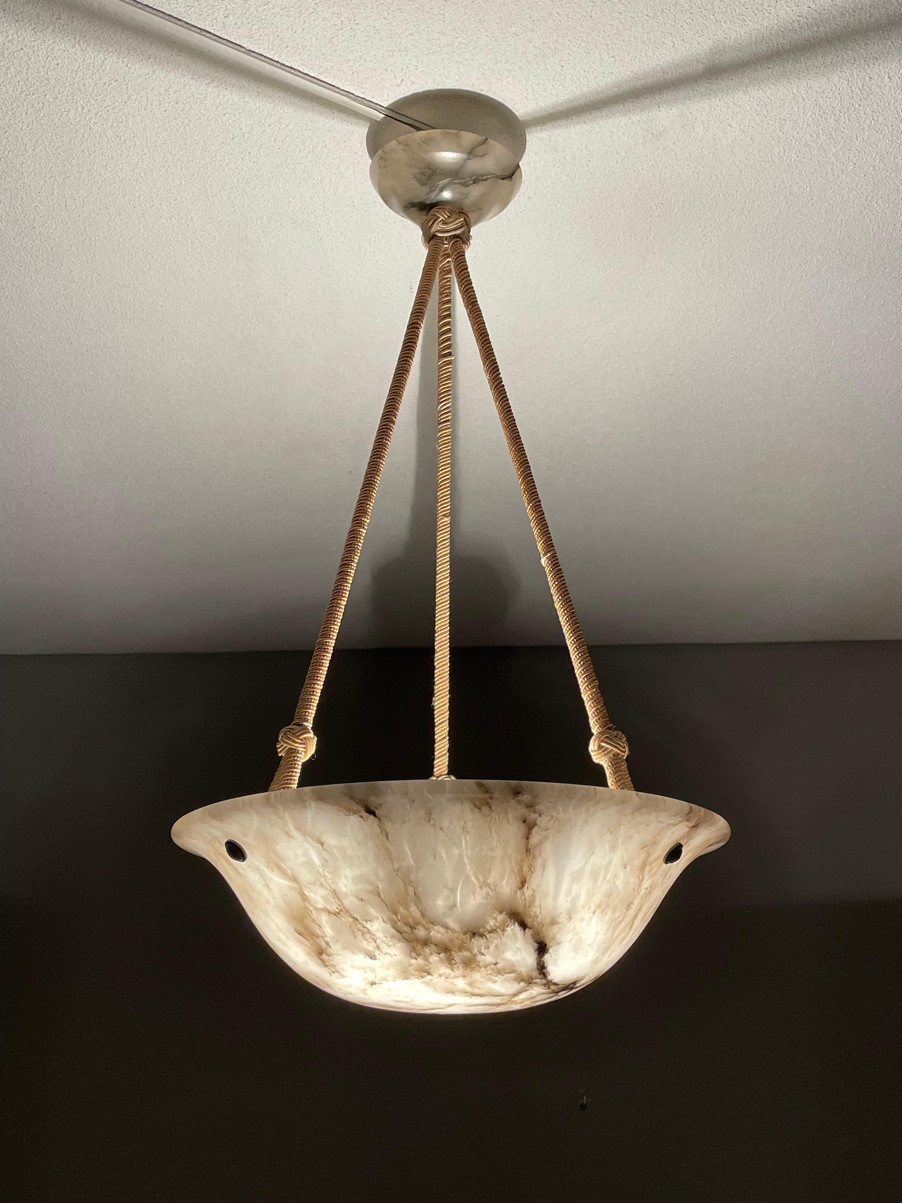 Exceptional alabaster pendant with a perfect shade and canopy.

Over the years we have seen and sold a number of alabaster pendants that were even better than the top quality ones that we sell regularly and this here specimen too fits that bill.