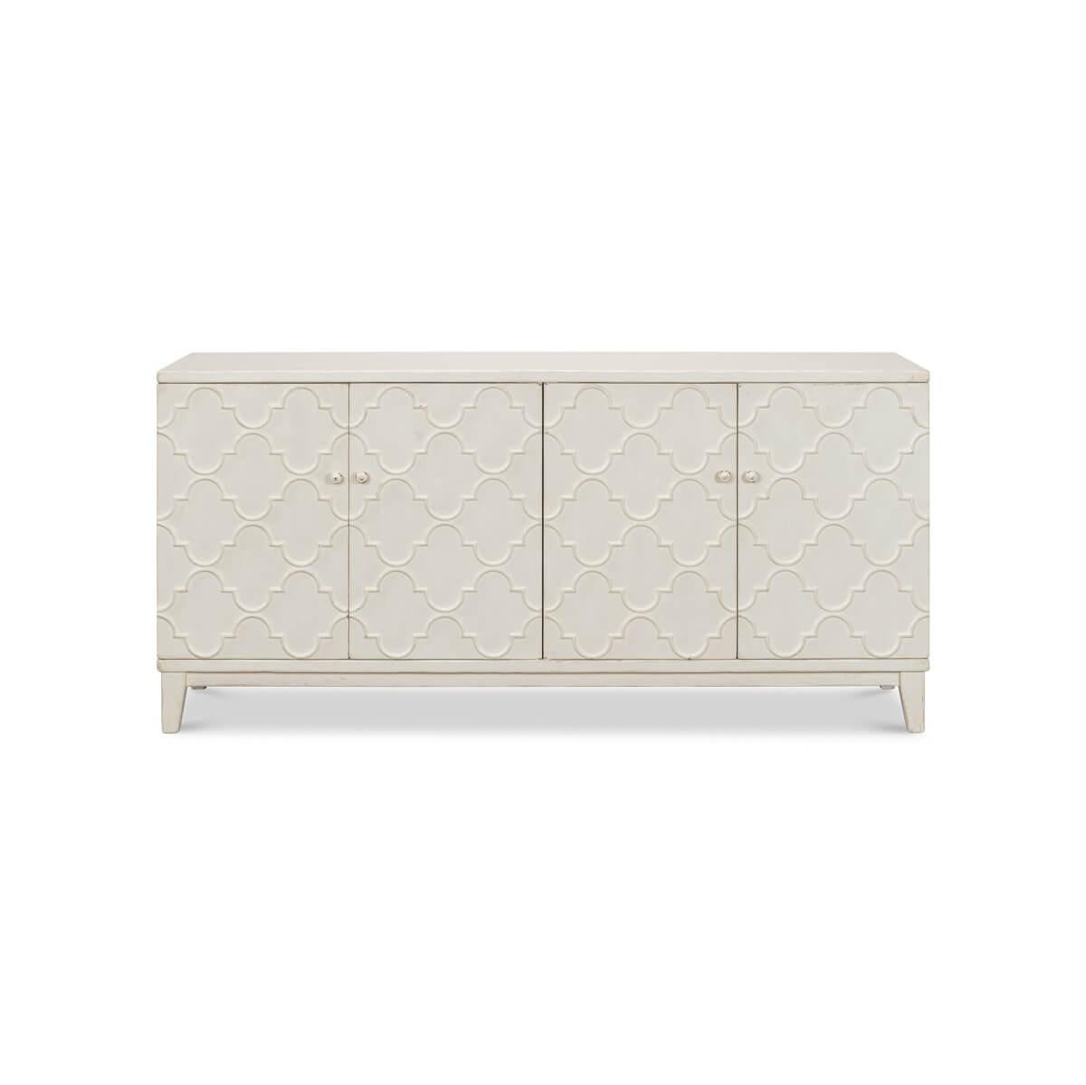 This exquisite piece boasts a tranquil white finish, gently distressed to reveal undertones of natural wood for a perfectly aged look. The front fascia is adorned with arabesque mosaic patterns, creating a captivating visual. Behind the four doors