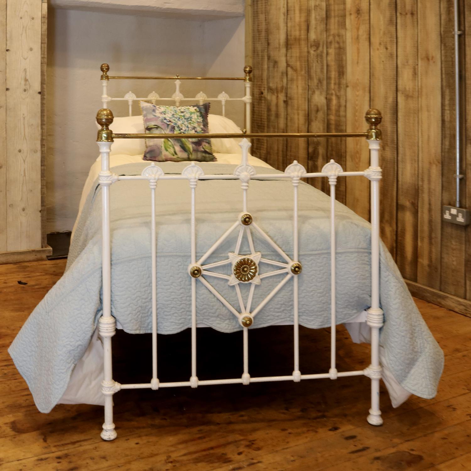 A traditional style Victorian antique bed painted in antique white. This bed is highly decorative, with stunning features, including fantail mouldings and a diamond central feature with brass plaques on the footboard. 

This bed accepts a standard