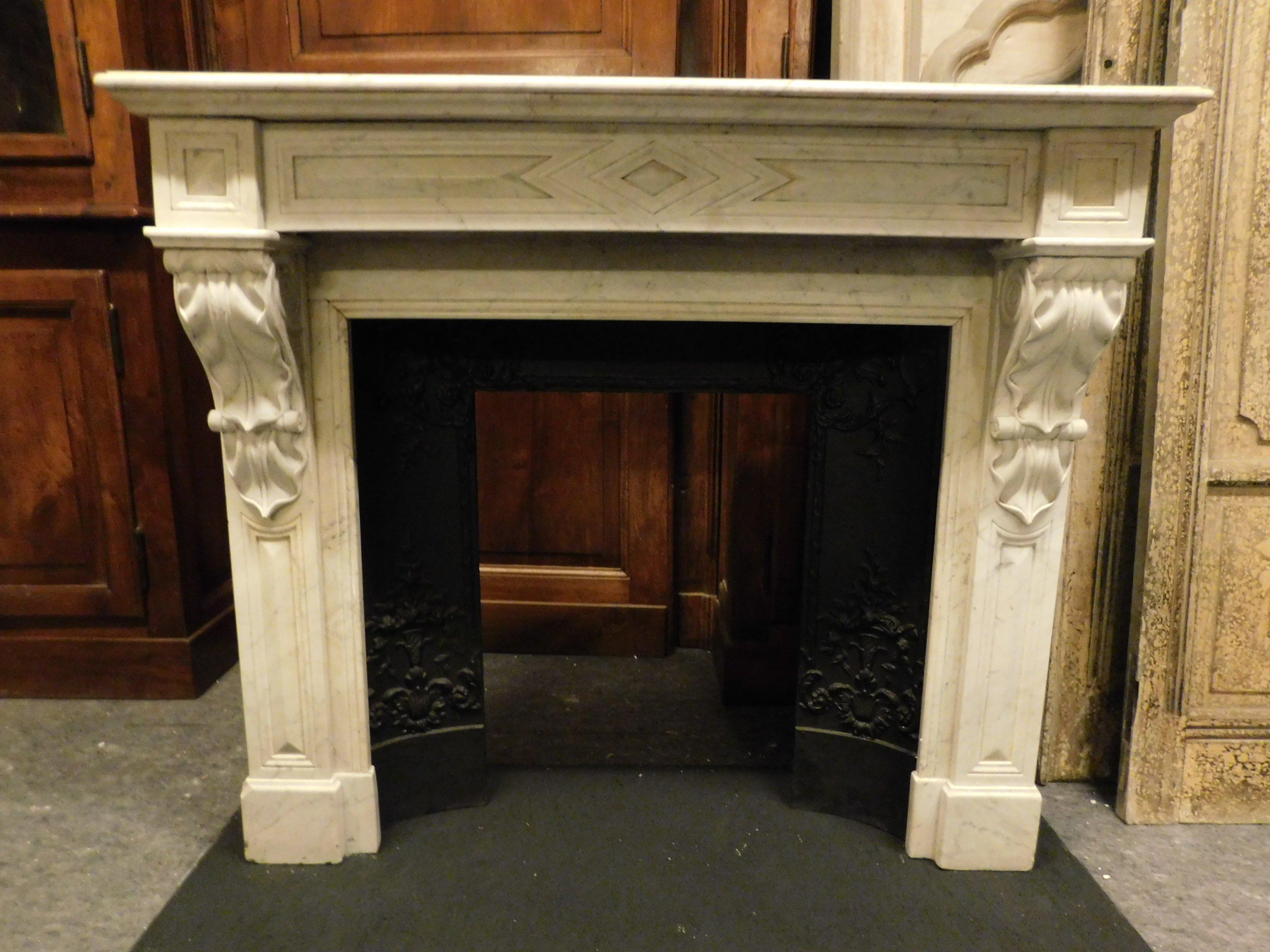 Ancient fireplace mantle in white Carrara marble, carved with geometric shapes and acanthus leaves on the sides, from France, from the 19th century. Sold without counter-heart in black cast iron, beautiful white marble, beautiful patina and in good