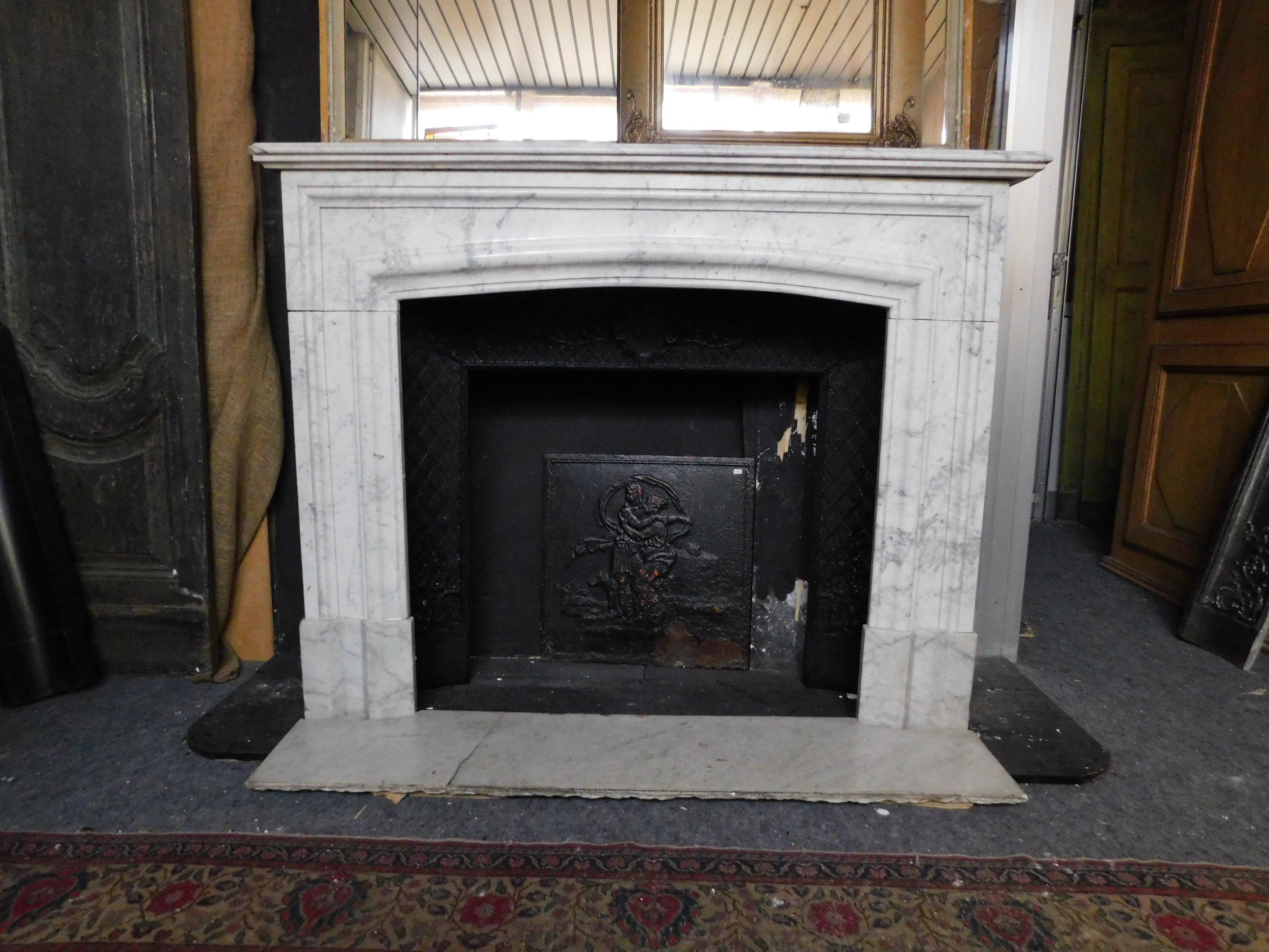 Antique fireplace in white Carrara marble, sculpted with a simple geometric shape but of great elegance as it was used at the time, built completely by hand in the mid-19th century for a palace in Italy (precisely Liguria) complete with original