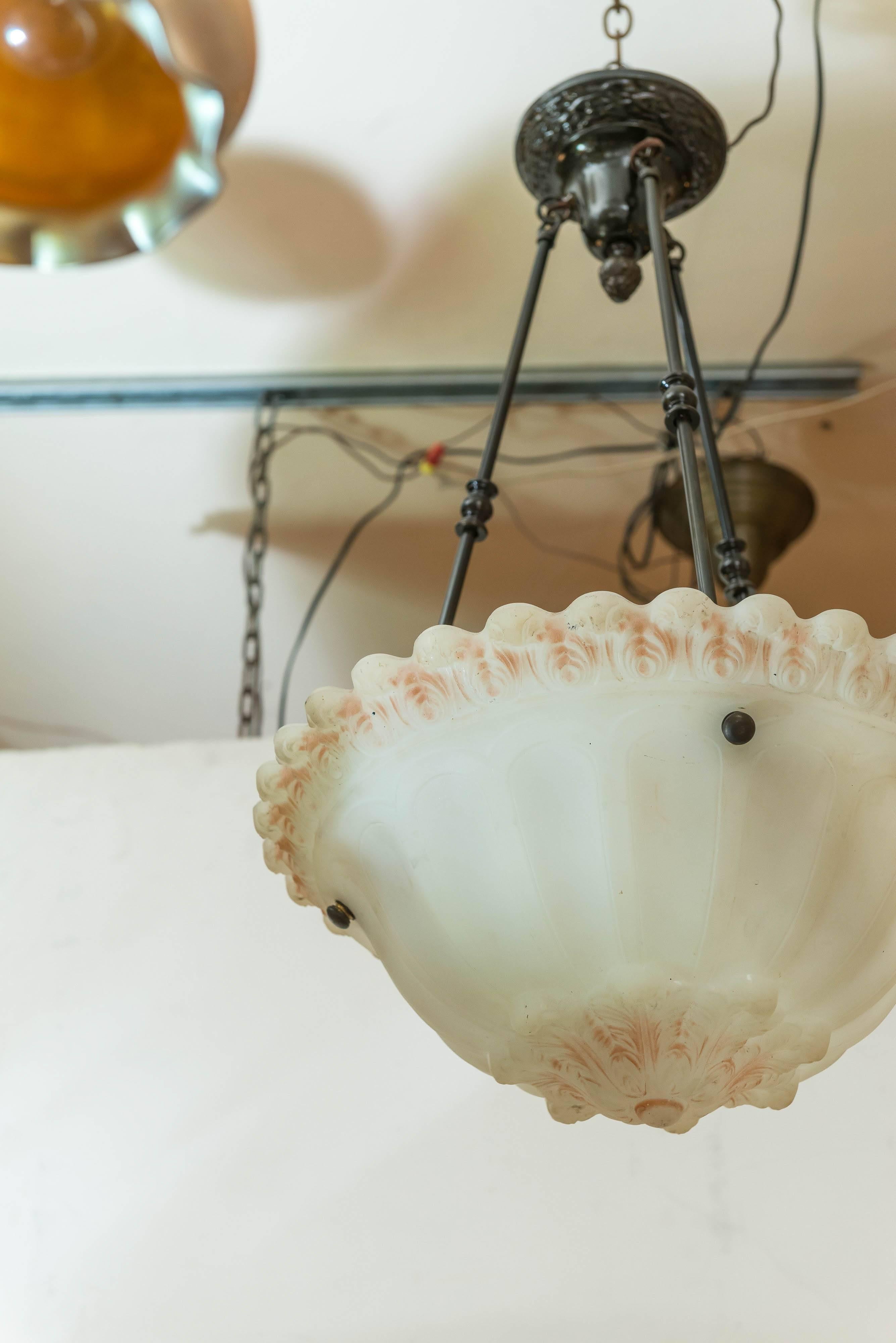 This American pendant has the unusual feature of having a scalloped border. It also much of the original factory painted highlighting. A very warm and inviting piece of antique lighting good for any room in your home. Newly wired, and ready for use.