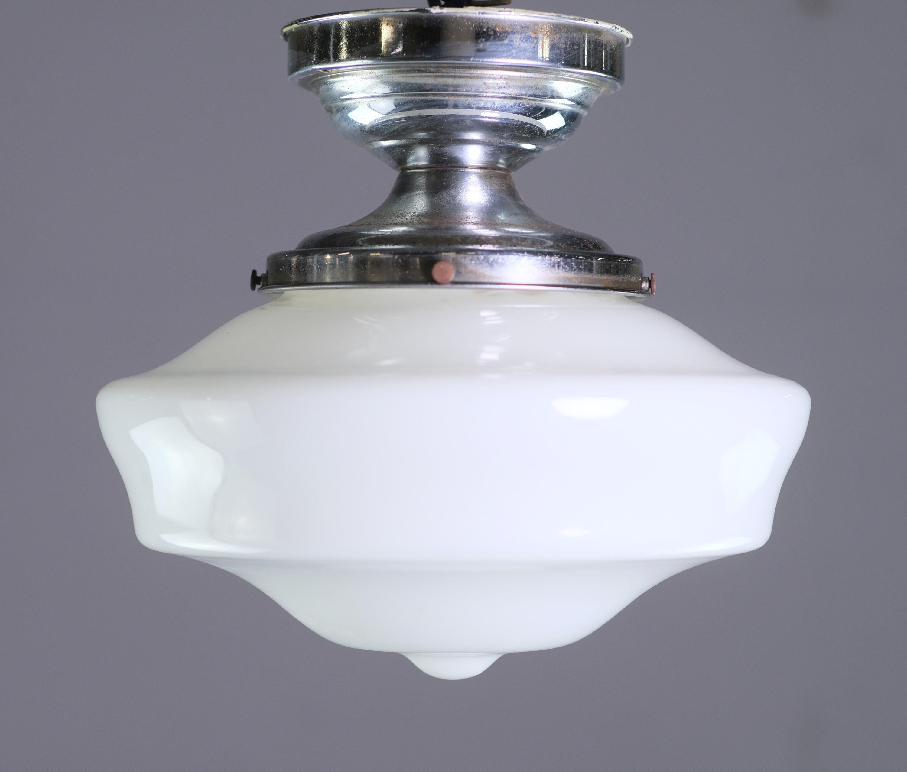 Early 20th century semi-flush schoolhouse light. Features original fitter and a stylish white schoolhouse shade. Small quantity available at time of posting. Please inquire. Priced each. Please note, this item is located in one of our NYC locations.