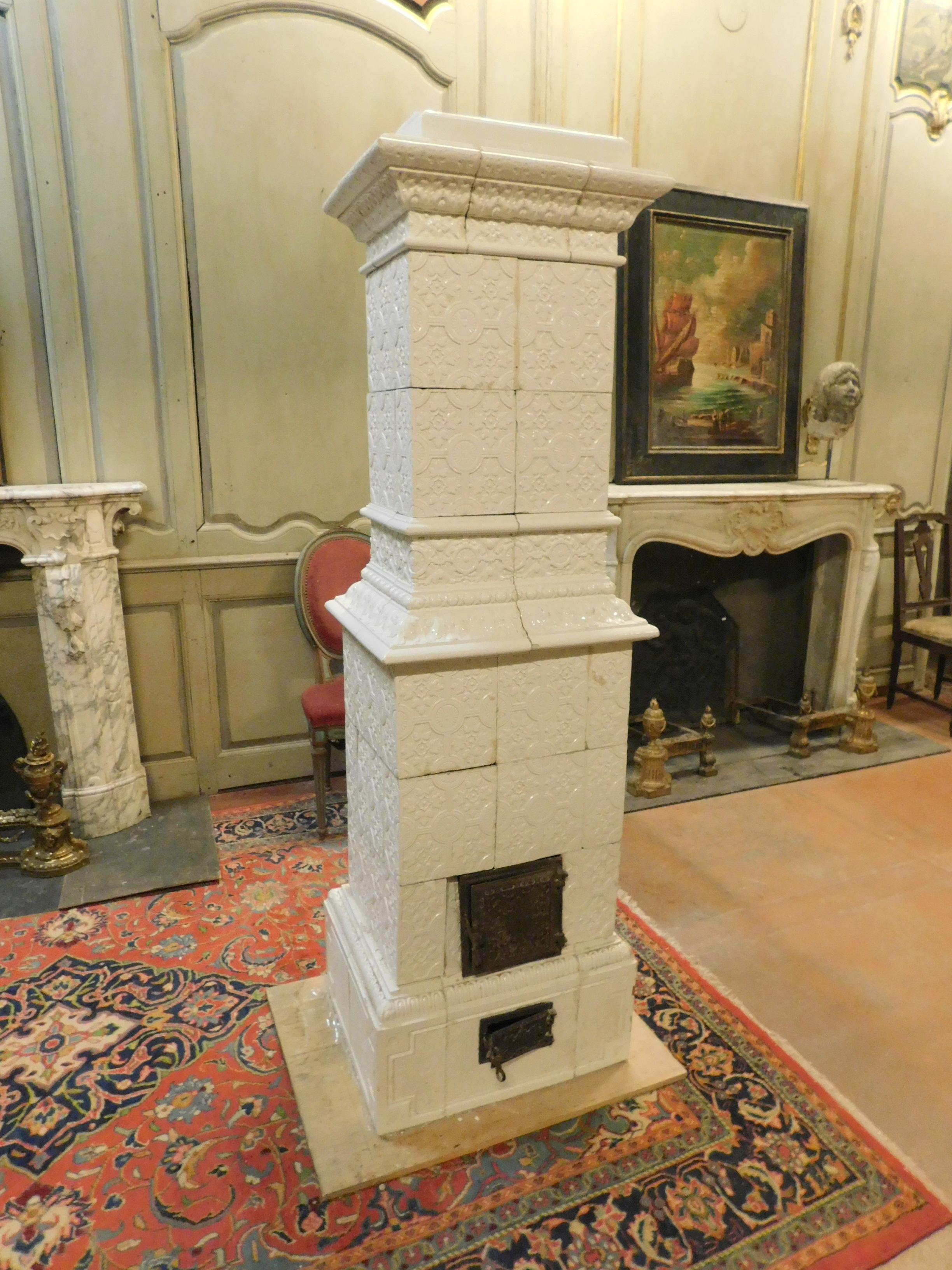 Ancient white majolica stove, composed and covered with beautiful hand carved tiles that create an interesting texture, a typical Italian product that was used to heat and embellish the most elegant rooms and guest reception halls. produced entirely