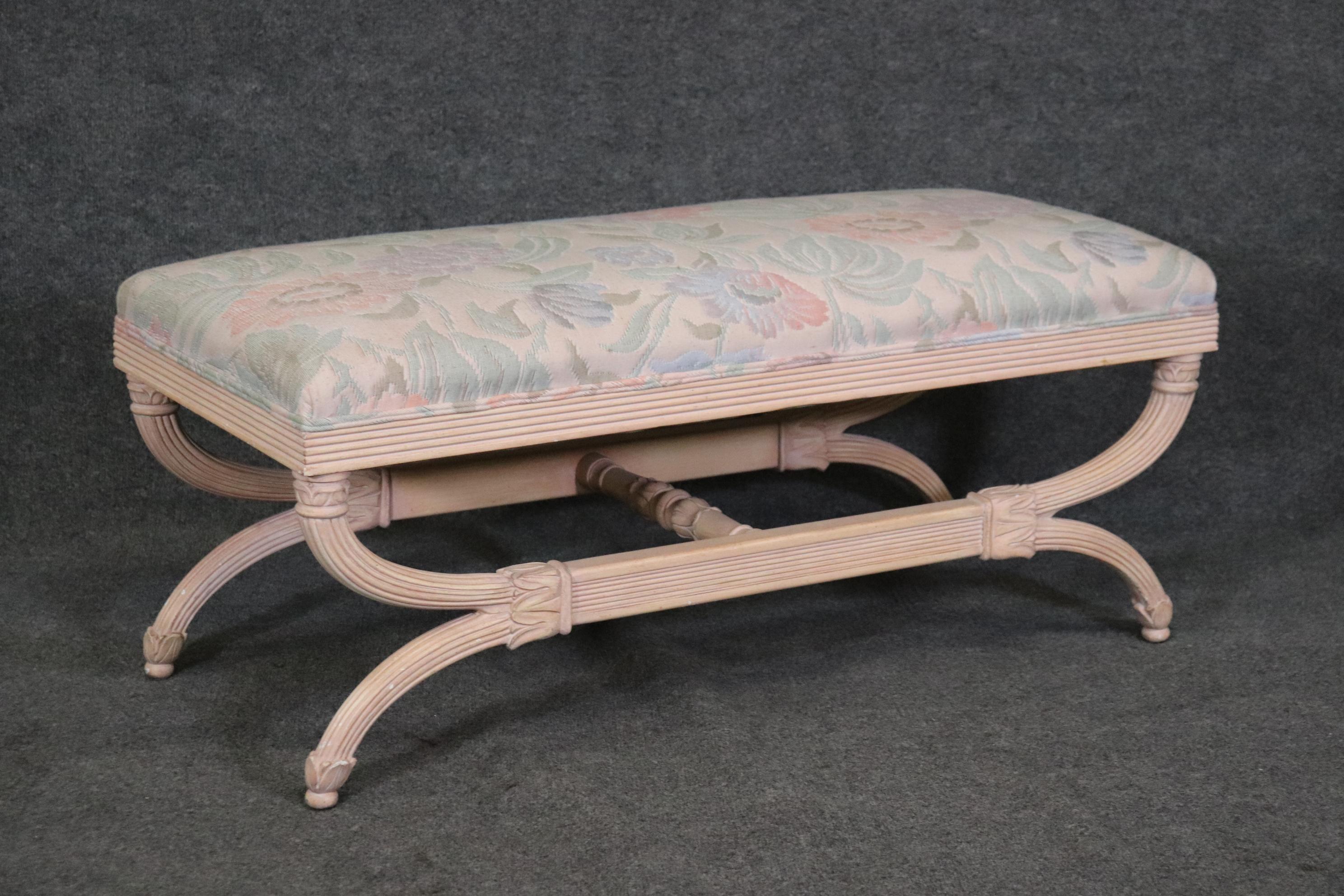 This is a beautiful antique white painted, floral upholstered becnh. Perfect for the end of a bed or by a window this bench will show some signs of age and use including a fine hairline crack shown, and some minor staining which may be cleaned. The