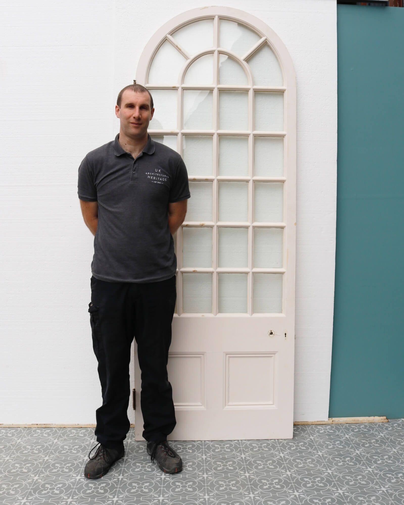 An antique late 19th century white pine arched glazed door suitable for interior use. Dating to circa 1870, this elegant door was sourced from a Victorian orangery in Tetbury, England.

It would look beautiful in a similar room, such as a