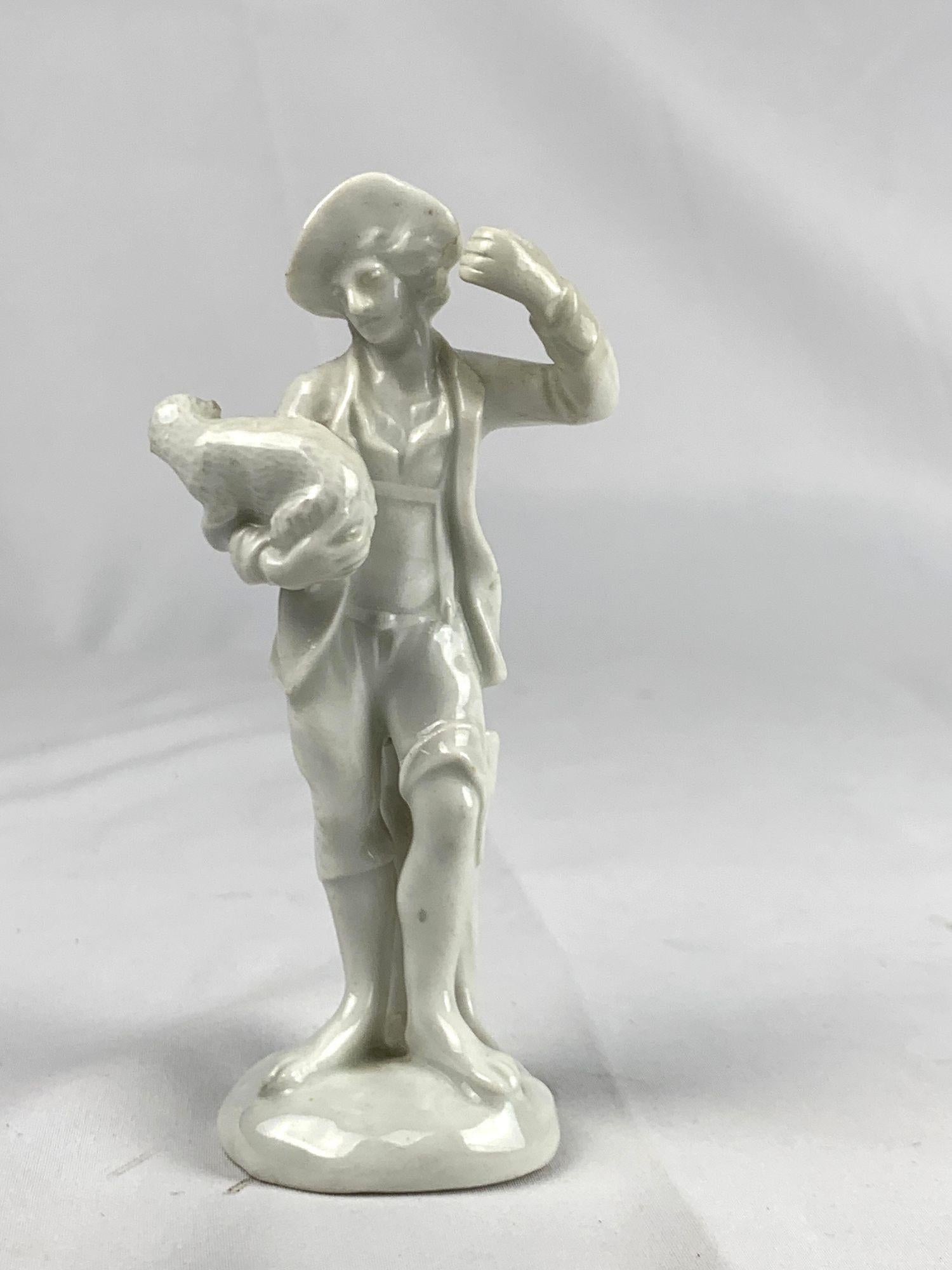 An antique white porcelain court figurine made by Ludwigsburg Porcelain circa 1765.
This unpainted figure represents a young man in 18th-century dress holding a lamb under one arm and gracefully lifting his other hand.
Left in pure white glaze, the