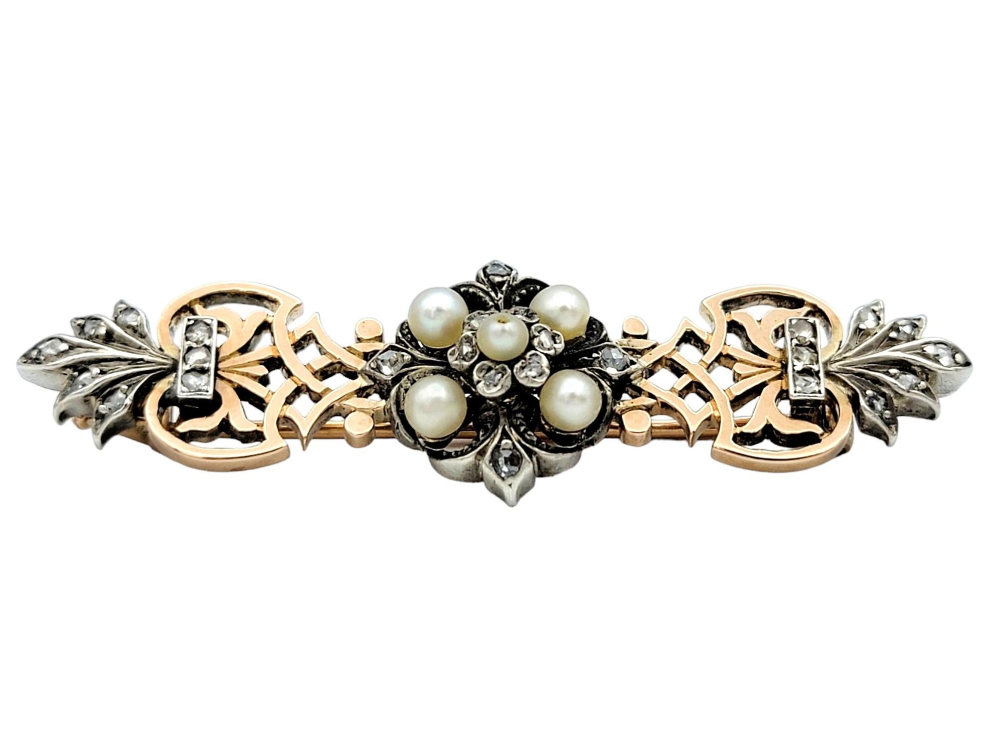 This exquisite antique brooch, crafted in 14 karat rose gold and adorned with lustrous seed pearls and sparkling diamonds, is a charming piece that is perfect for any occasion. Each pearl is meticulously set within the warm rose gold setting, adding