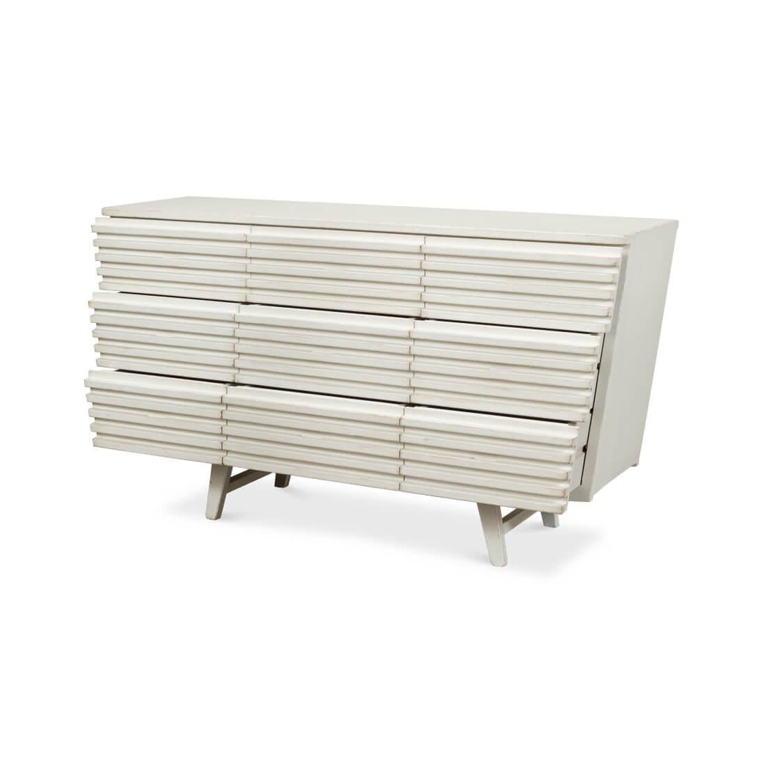 Inspired by Aztec architecture. This piece makes a statement with its ribbed pine facade with a slat design and Antique White finish. This unique geometric piece has nine spacious drawers.

Dimensions: 66