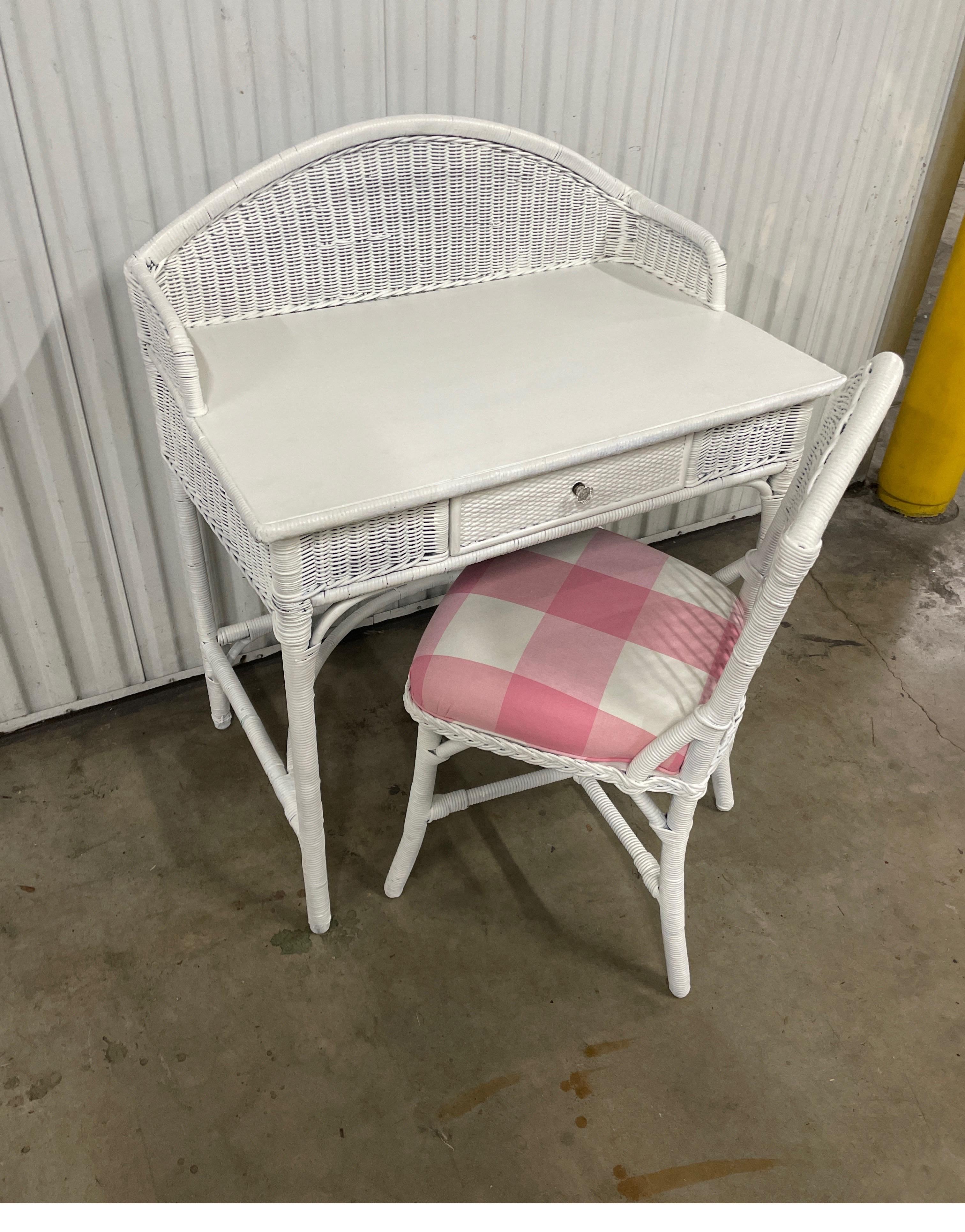 Charming antique wicker vanity / desk with matching chair. Chair seat cushion has been reupholstered in a pink & white plaid cotton fabric. A very sweet set!.